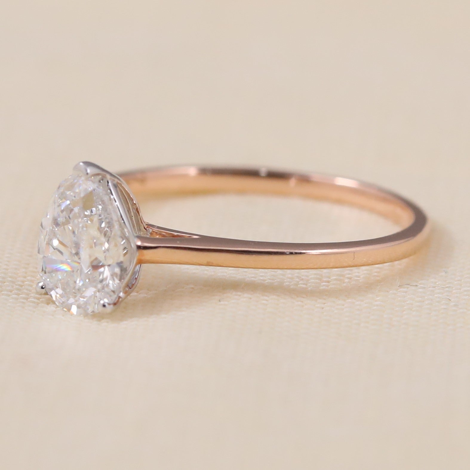 Elegant pear lab grown diamond ring set on a simple rose band.