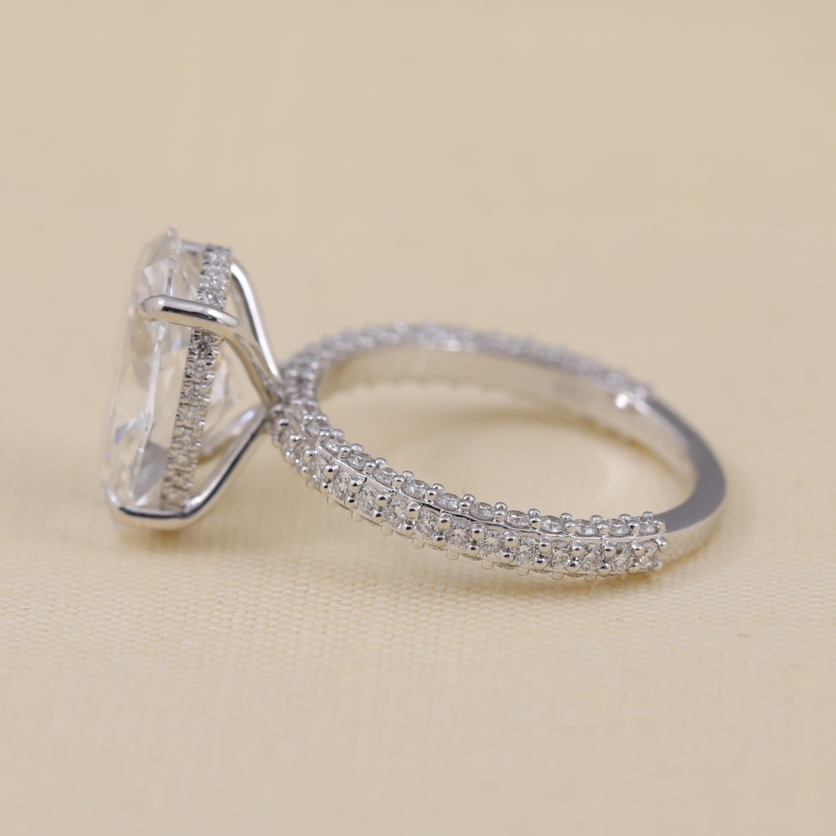Sparkling oval lab grown diamond ring crafted with a delicate pavé band