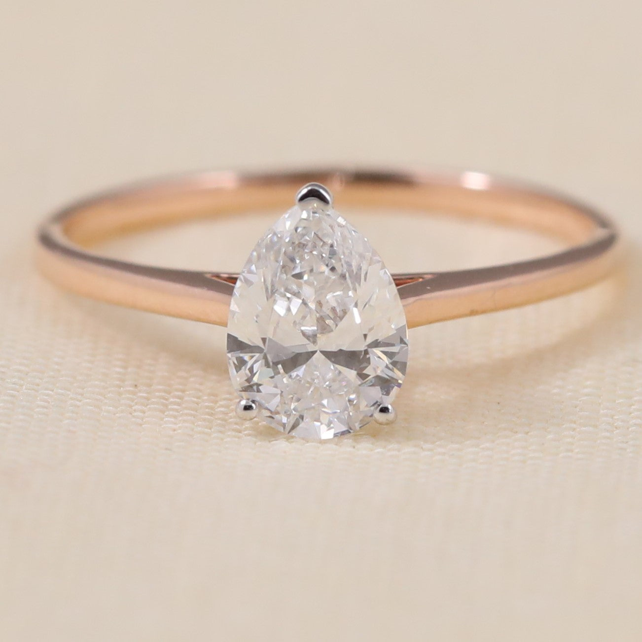 Pear shaped lab grown diamond solitaire ring with a sleek minimalist band