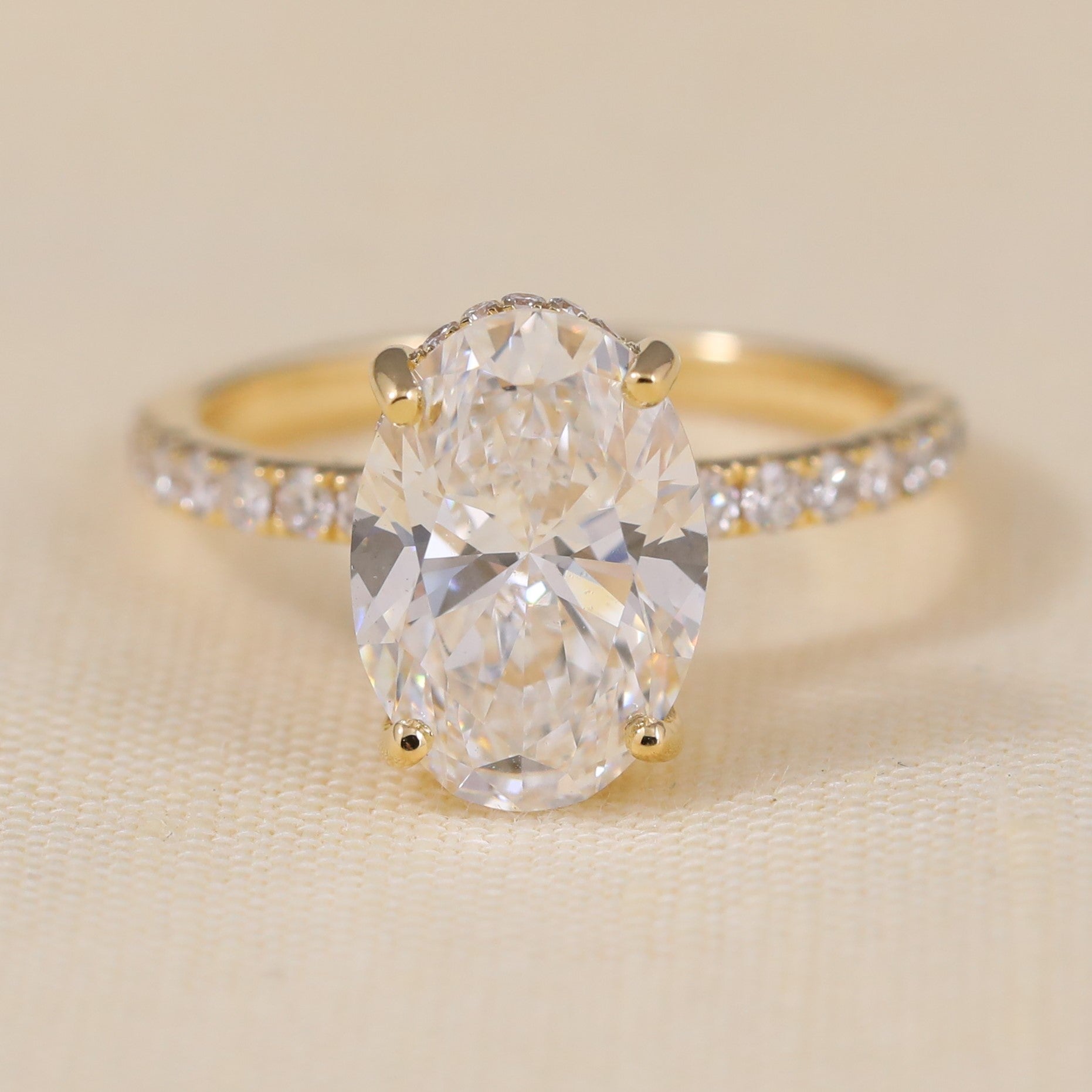 Oval solitaire engagement ring with sparkling band for elegant bridal style