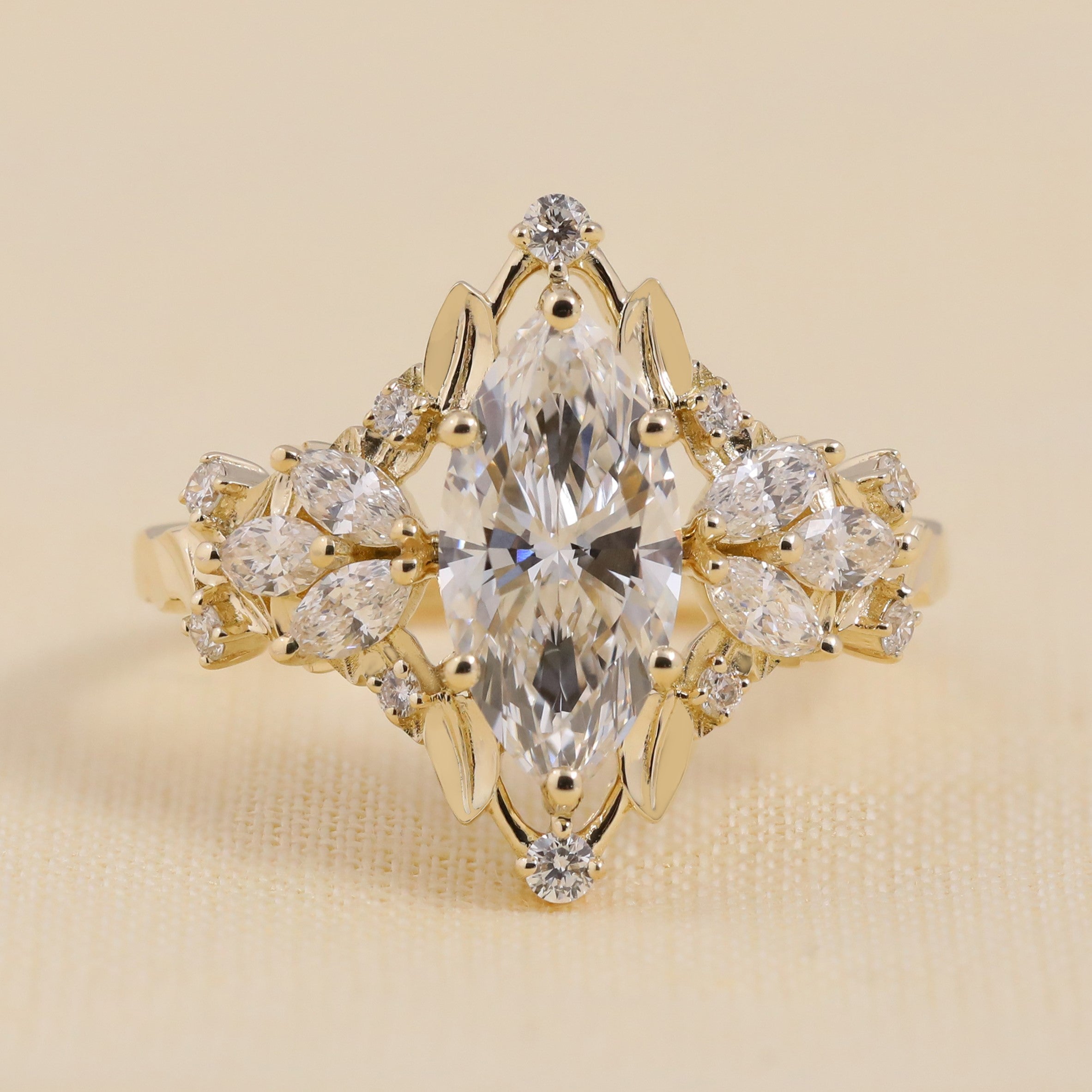 Vintage-inspired marquise-cut engagement ring with intricate diamond cluster halo