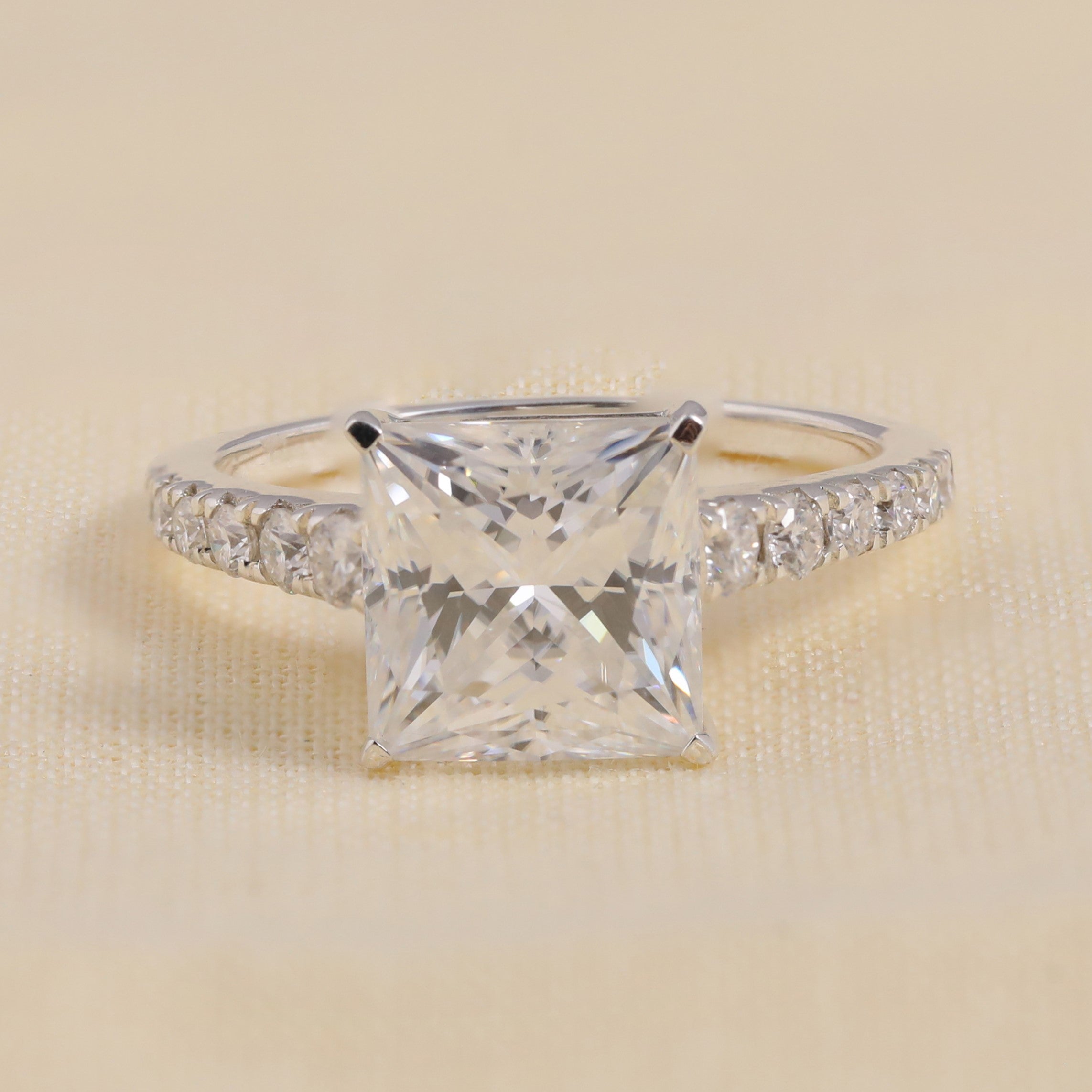 Princess cut diamond engagement ring with pavé band in white gold