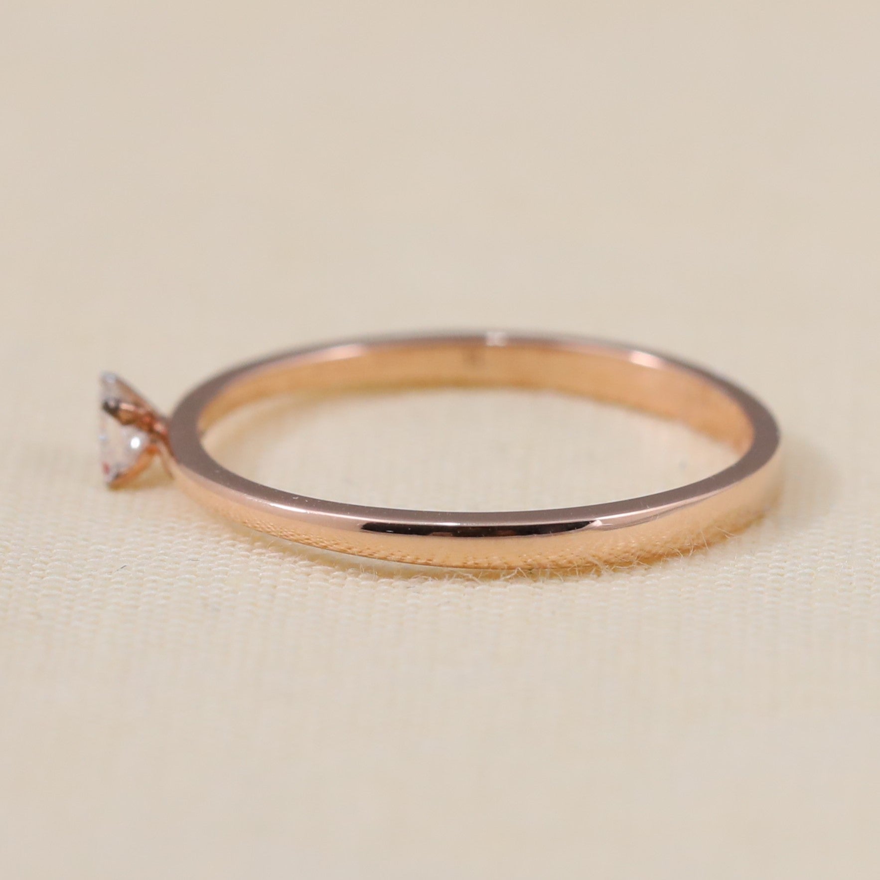 Delicate minimalist ring featuring a small princess-cut lab-grown diamond centerpiece