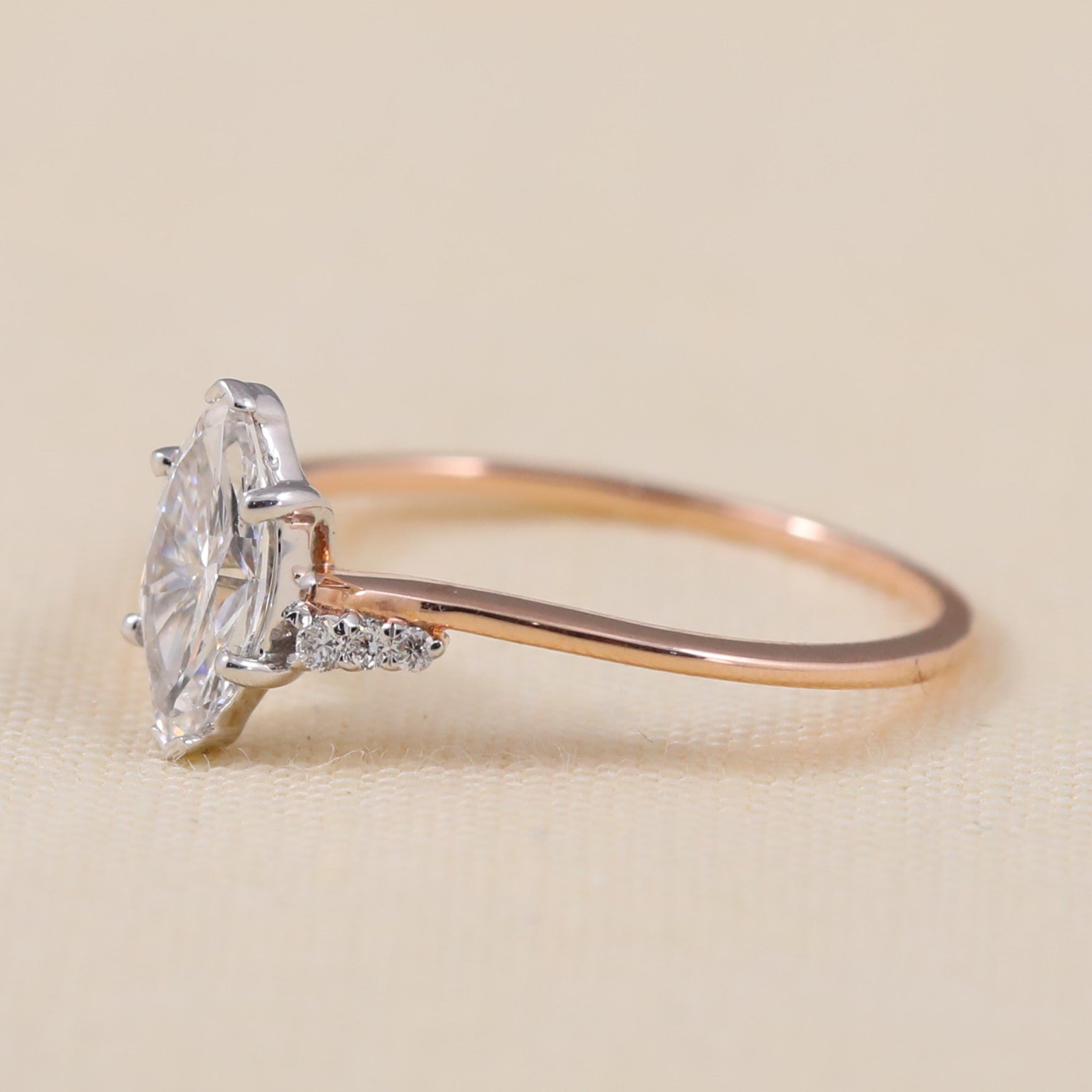 Delicate ring showcasing a marquise lab grown diamond with sparkling accents