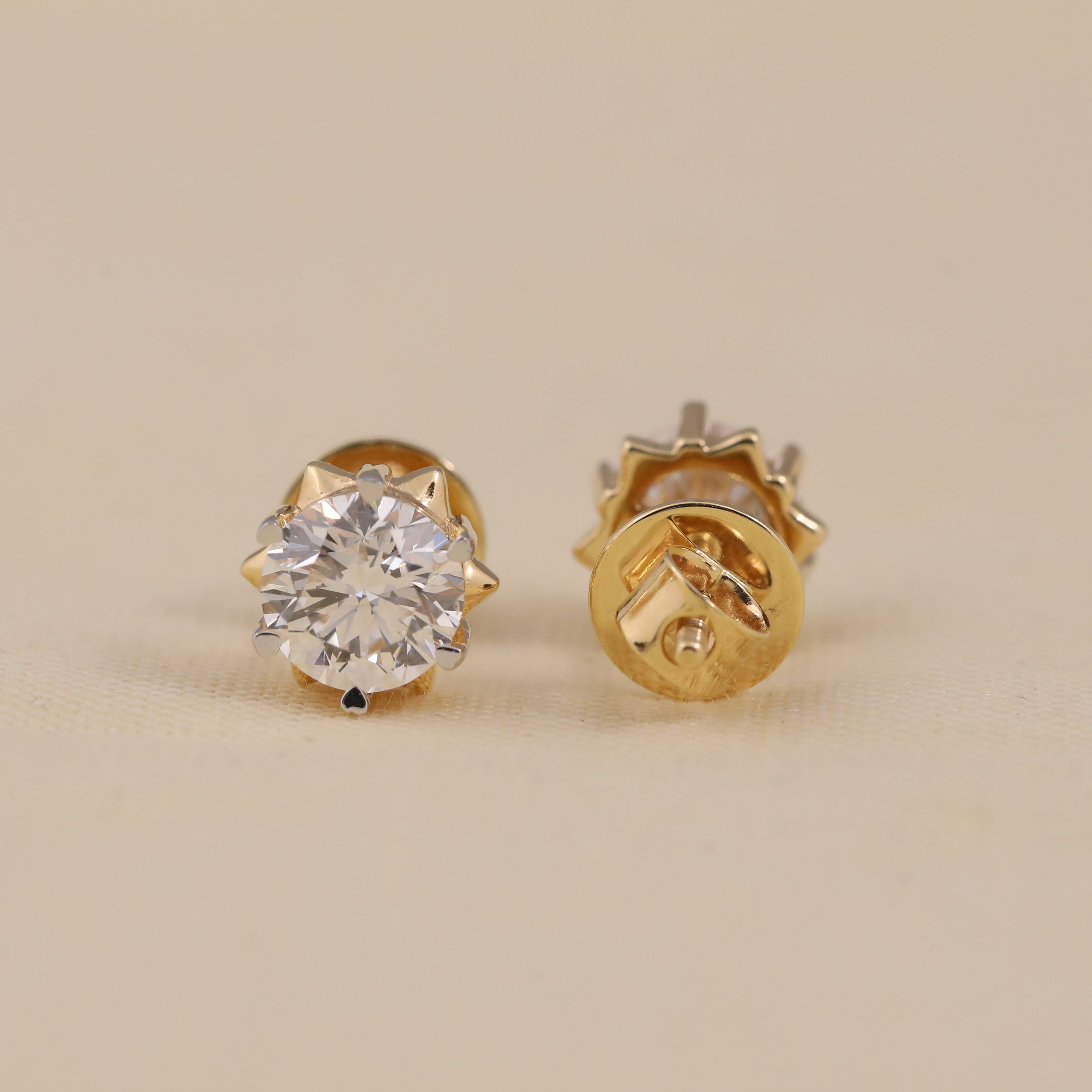 Classic solitaire diamond studs ideal for engagement or festive occasions.