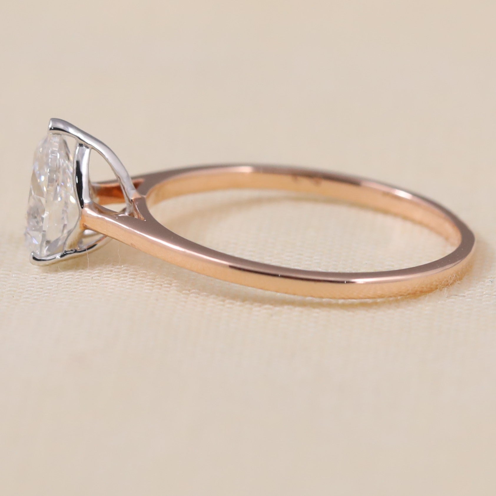Minimalist pear lab grown diamond engagement ring with classic solitaire design.
