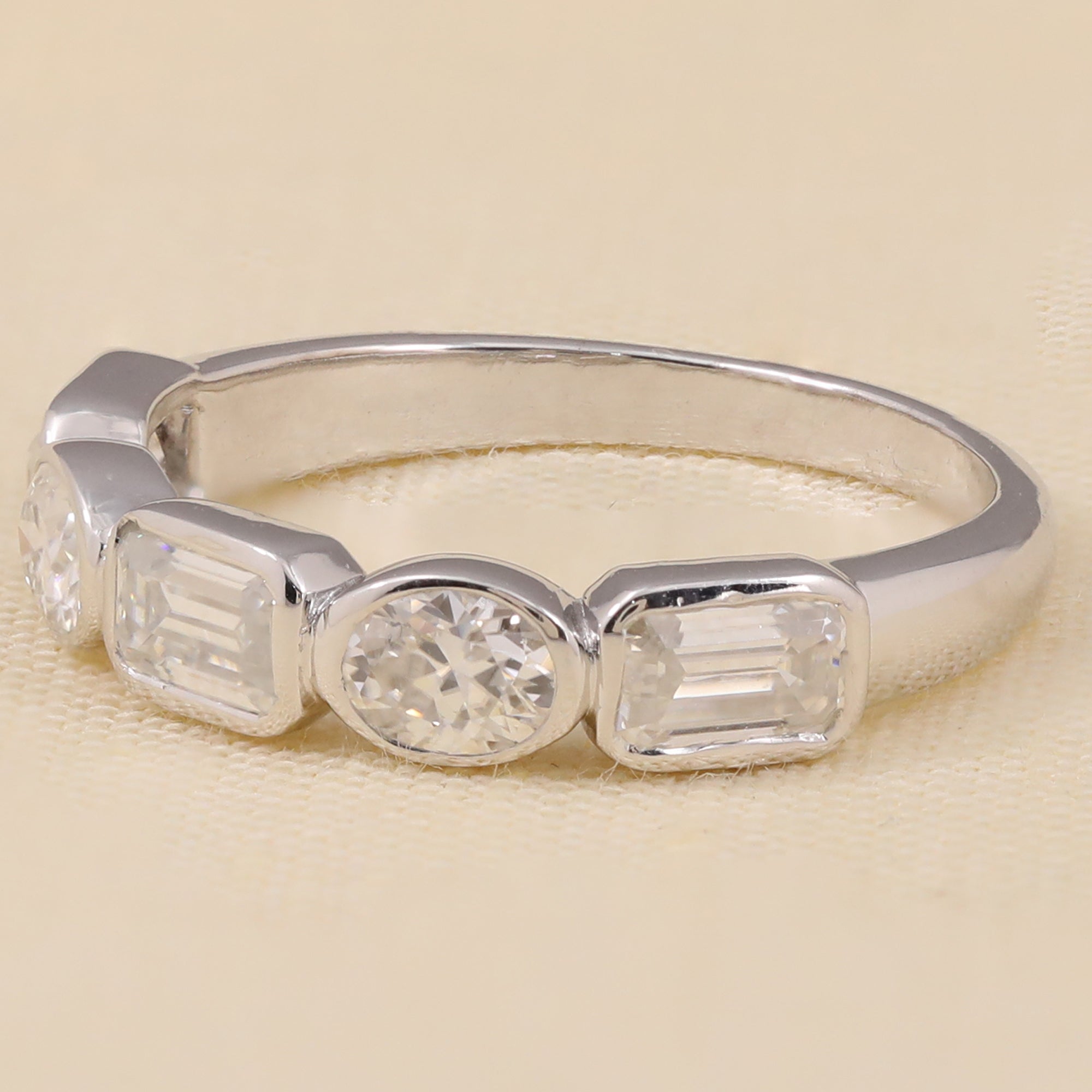 Mixed-shape lab diamond ring with emerald-cut, oval, and round diamonds set across the band