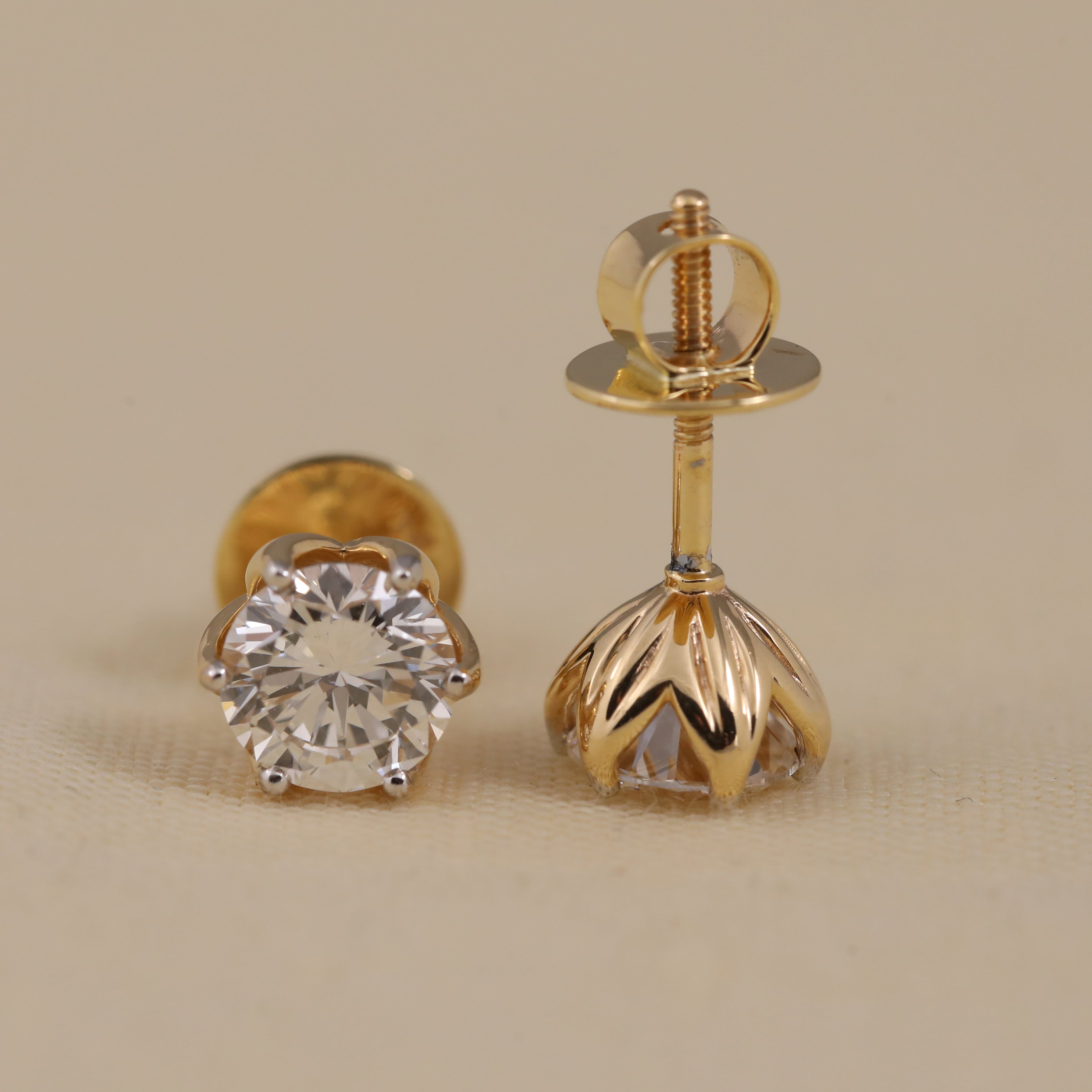Round-cut diamond stud earrings perfect for engagement and anniversary gifting.