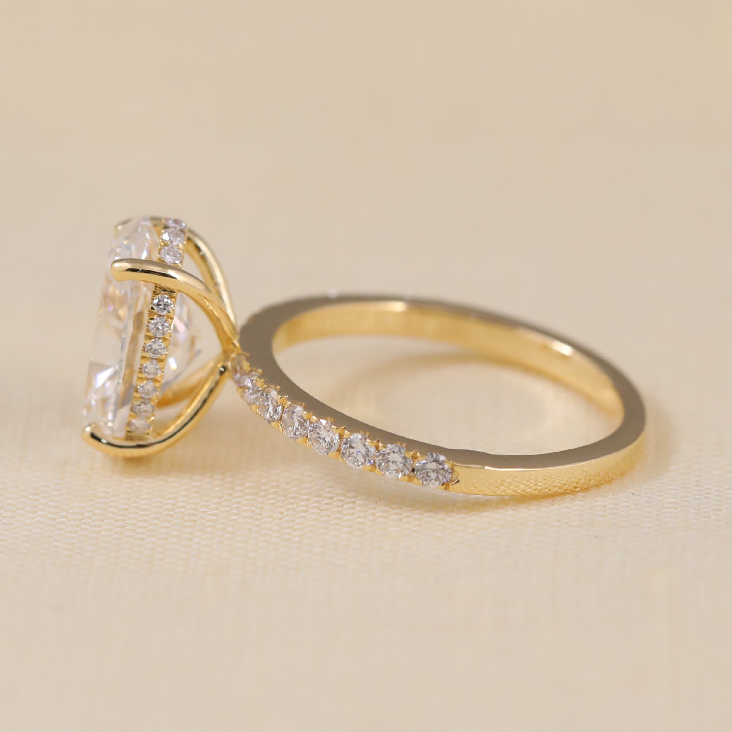 Classic oval-cut engagement ring designed with shimmering stones along the band.