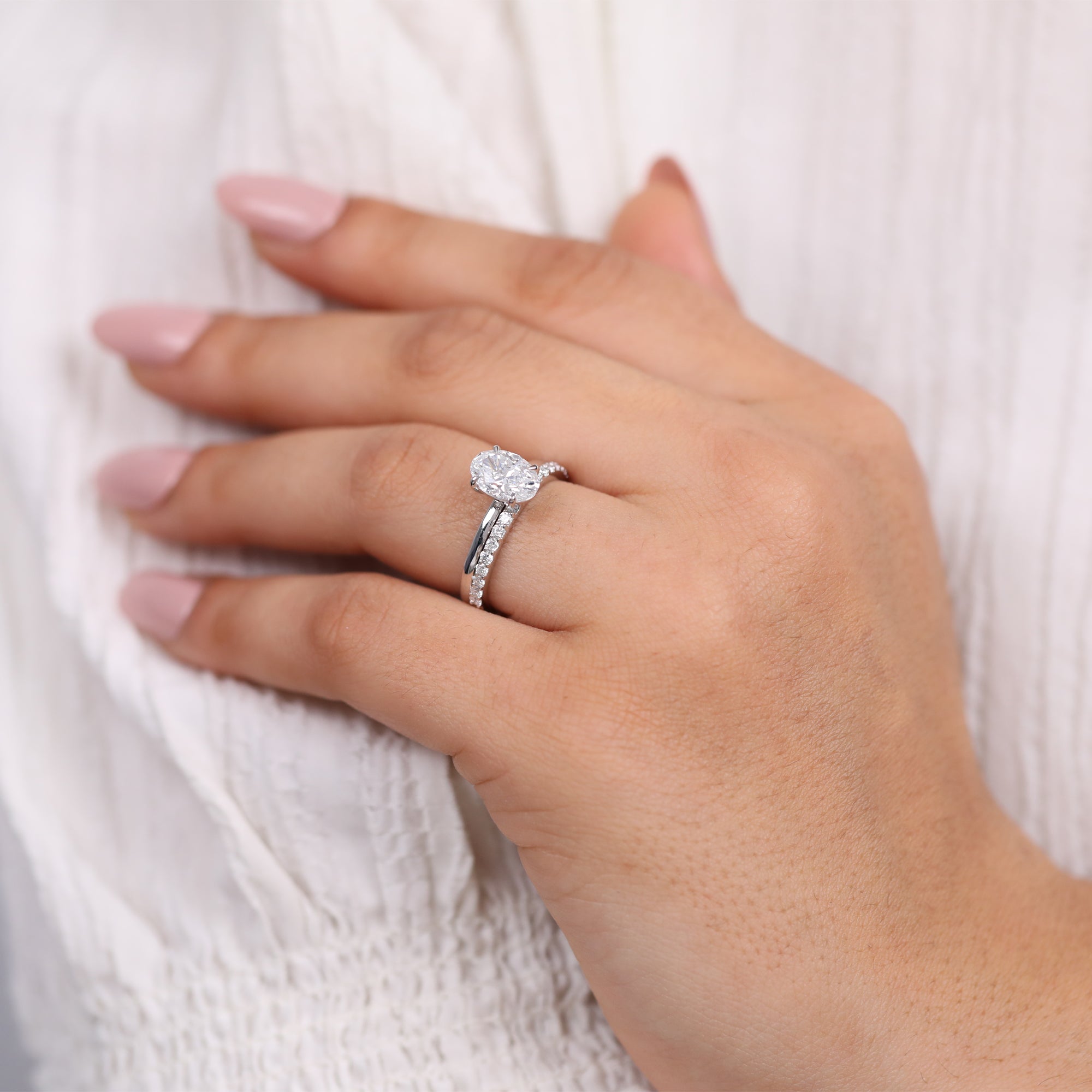 Luxury white gold oval diamond bridal set with sparkling pavé accents
