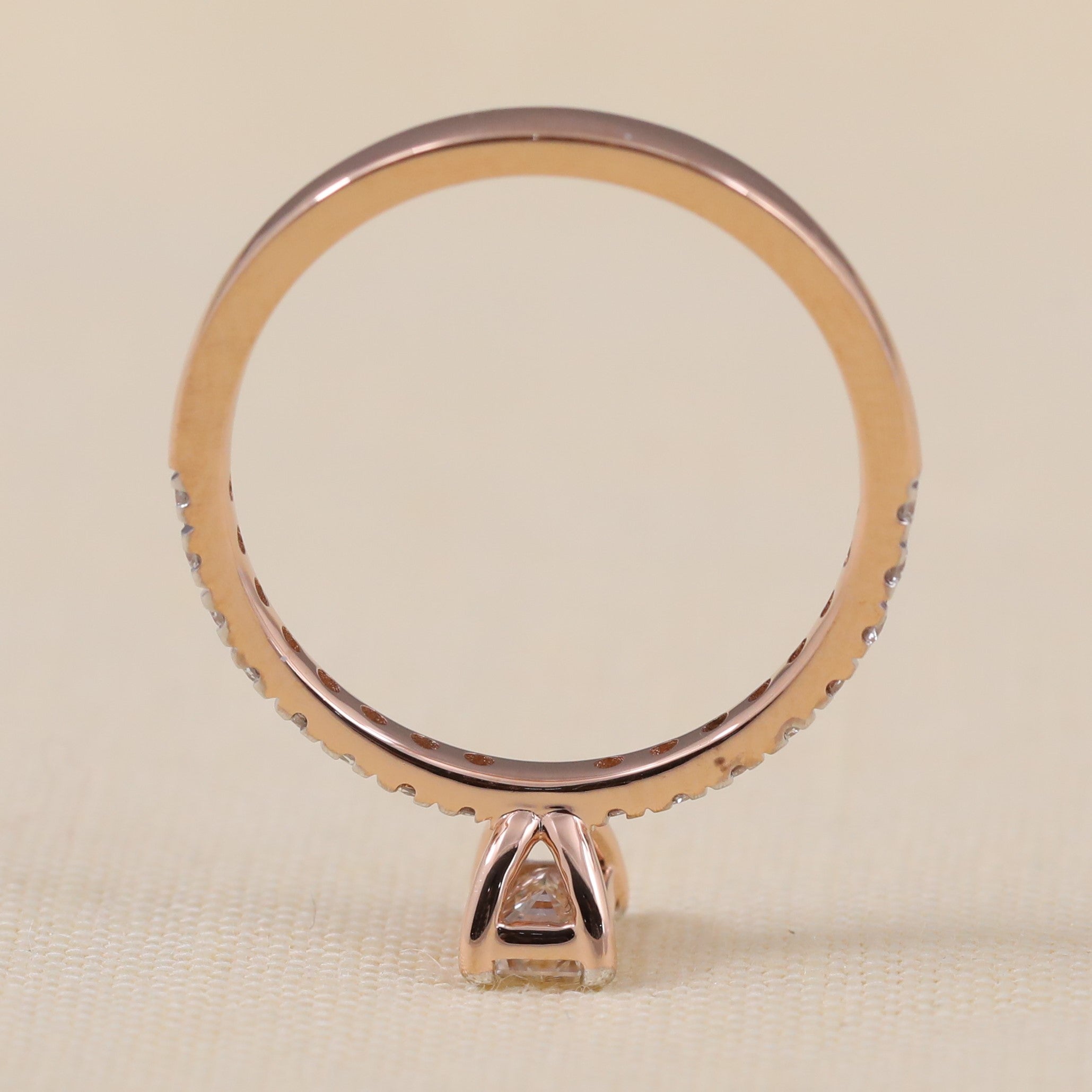 Slim pavé ring crafted with a radiant emerald cut lab grown diamond