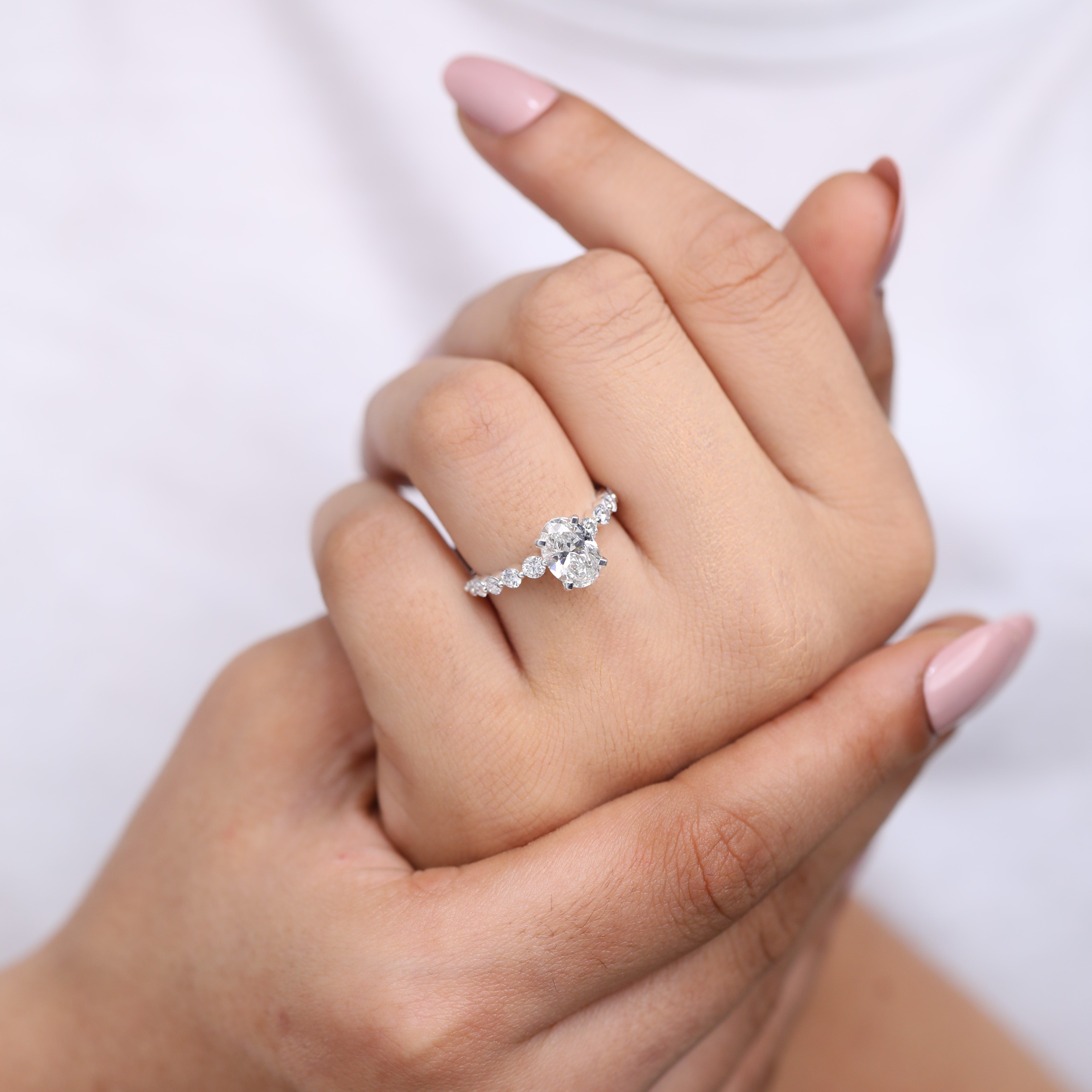 Oval lab-grown diamond bridal ring with a shimmering accent diamond band