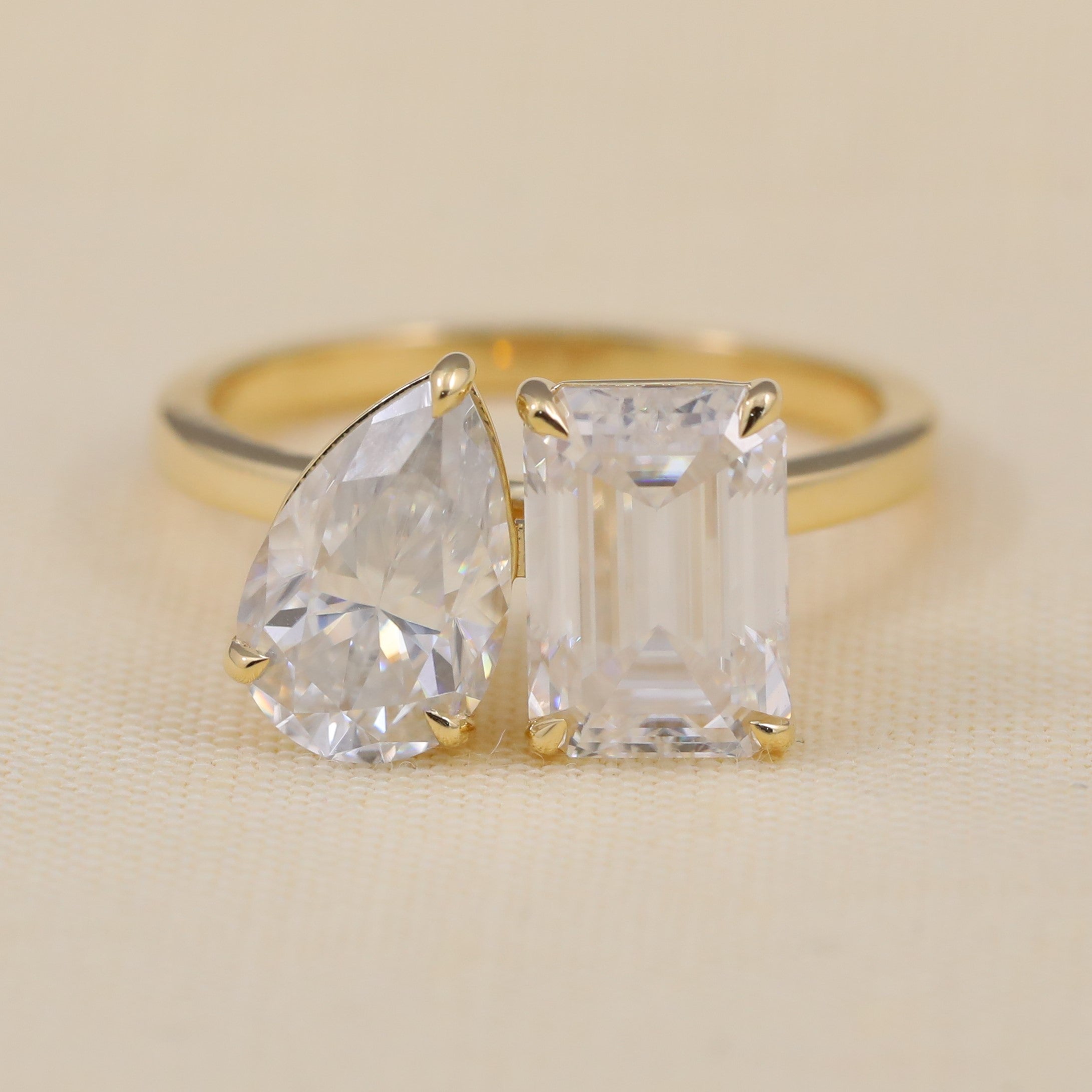 Toi et moi ring featuring pear and emerald cut lab grown diamonds