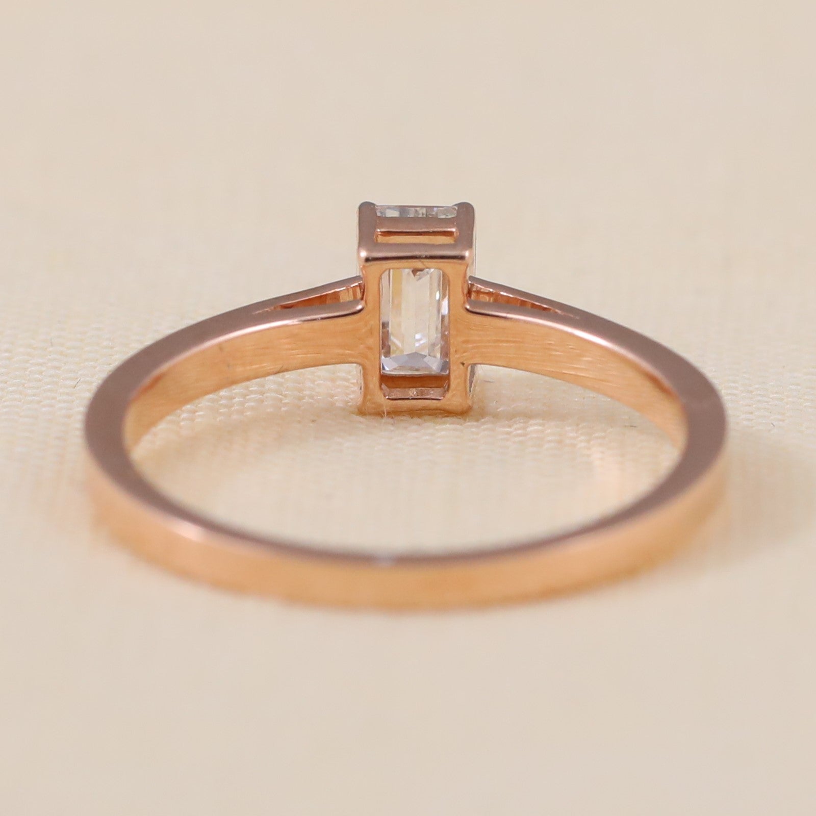 Minimalist ring highlighting a bright emerald cut ethical lab grown diamond stone