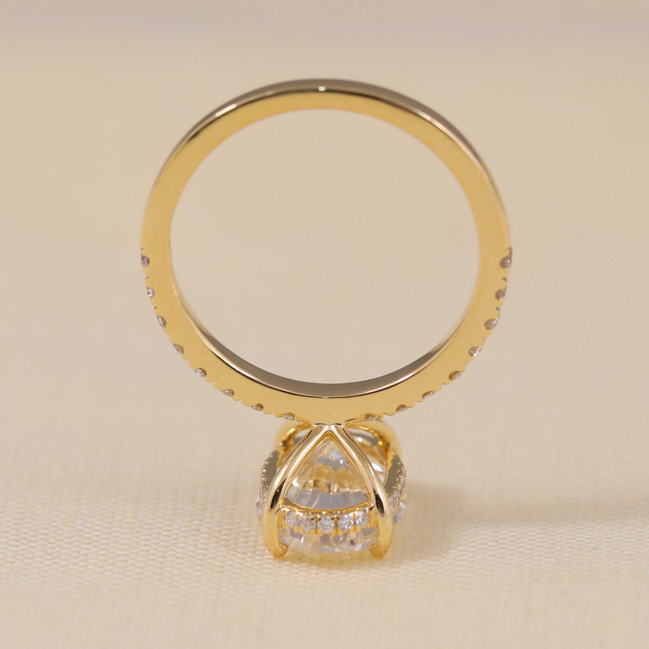 Luxury oval engagement ring crafted with shimmering stones along the shank