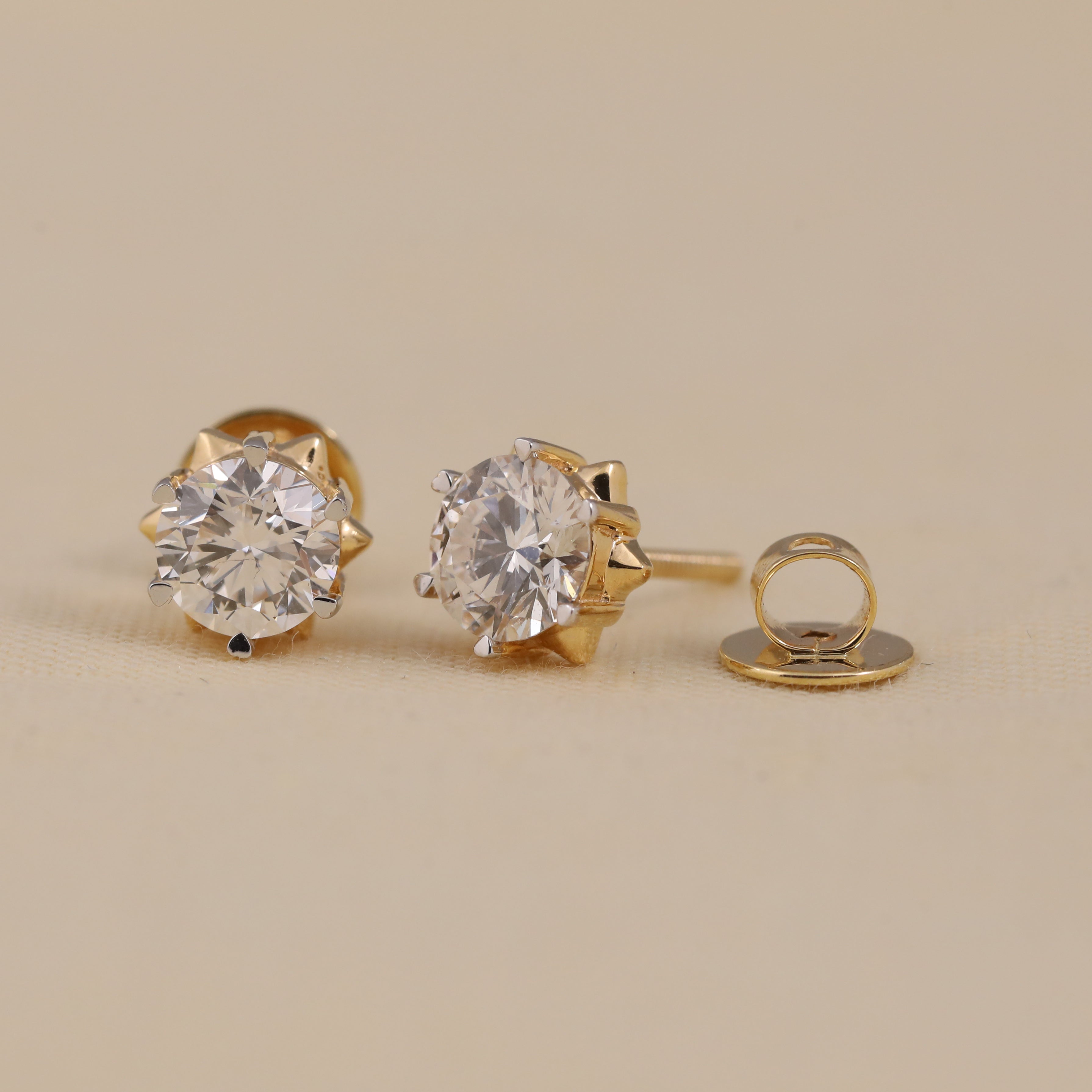 Timeless round solitaire diamond earrings ideal for engagement gifting.