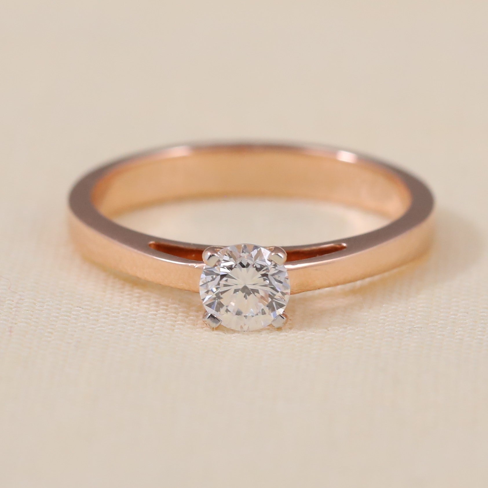 Round lab grown diamond solitaire ring featuring a sleek modern band design.