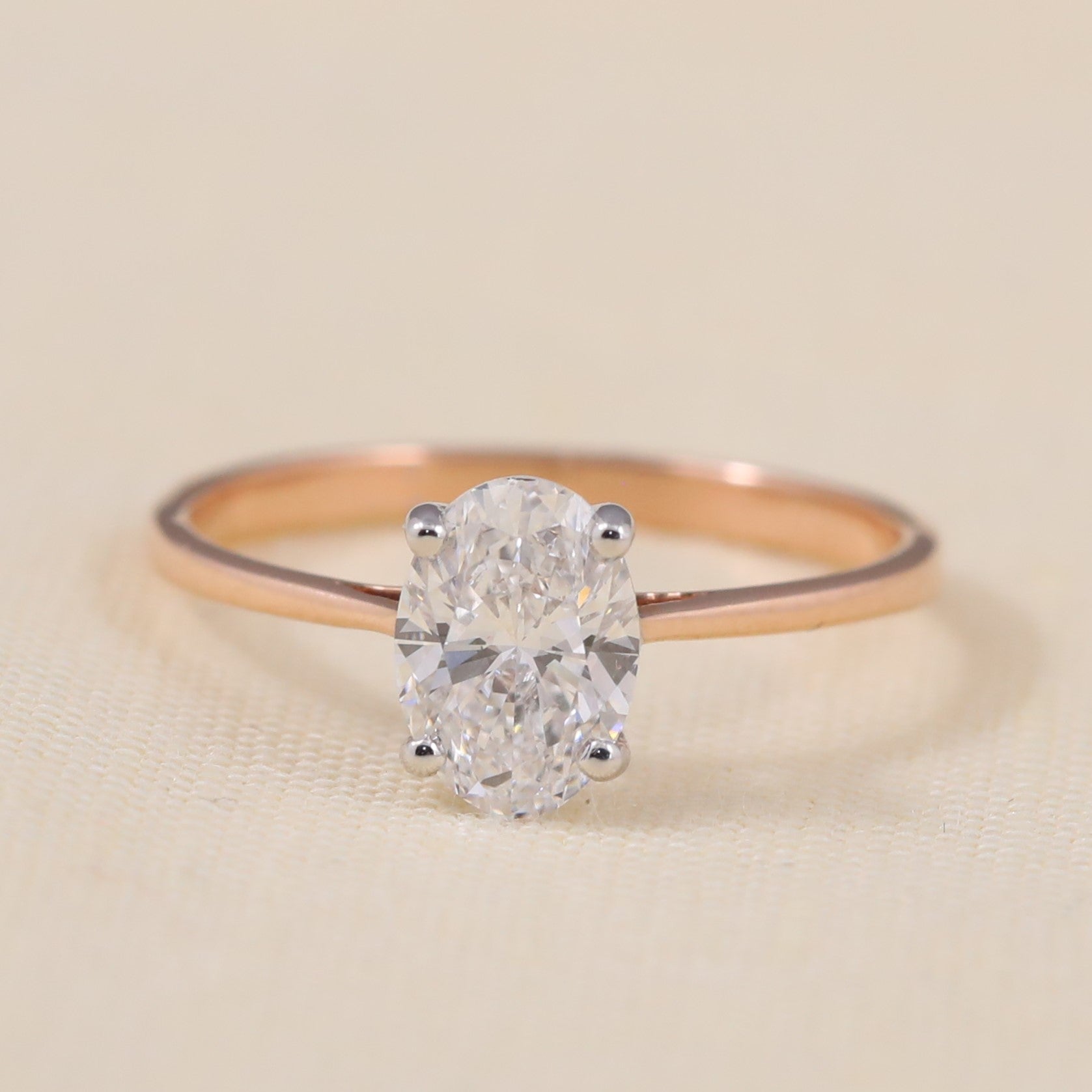 Oval lab grown diamond solitaire ring featuring a sleek, minimalist band