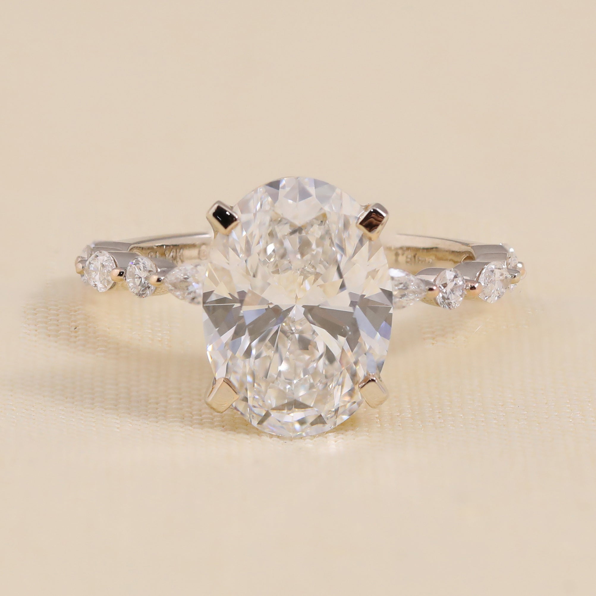 Elegant oval lab grown diamond solitaire ring with marquise and round accented band