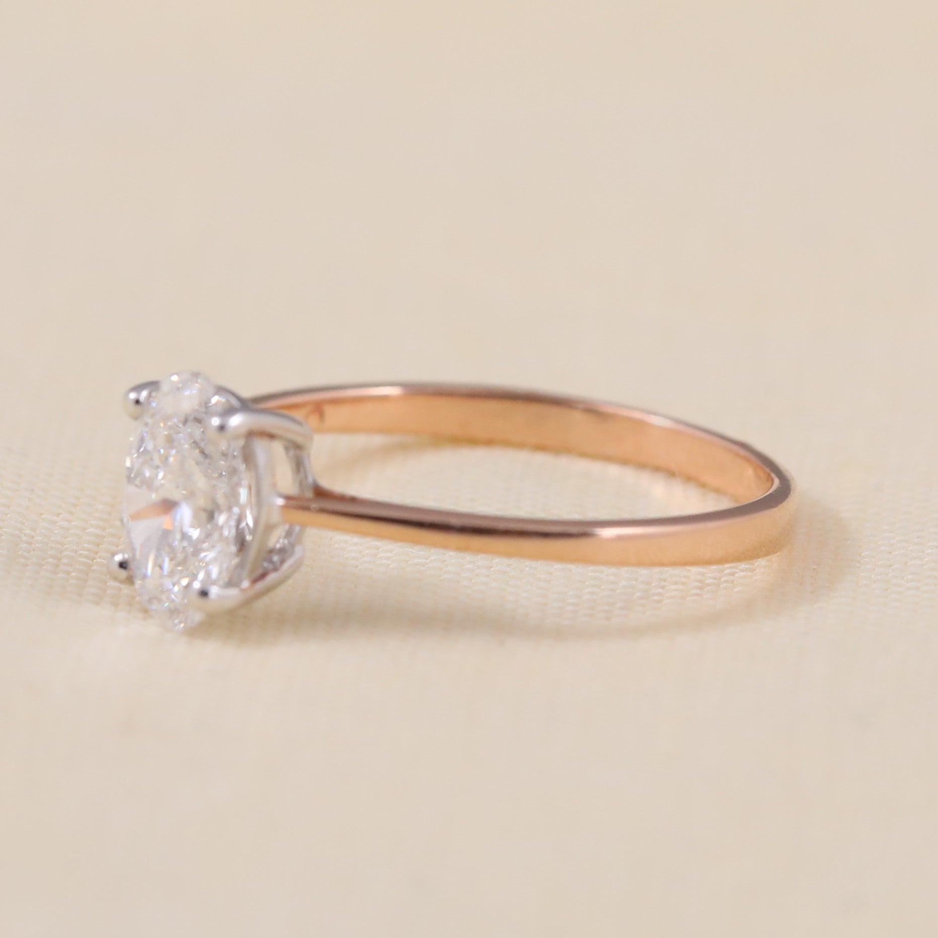 Elegant oval lab grown diamond ring set on a simple rose band.