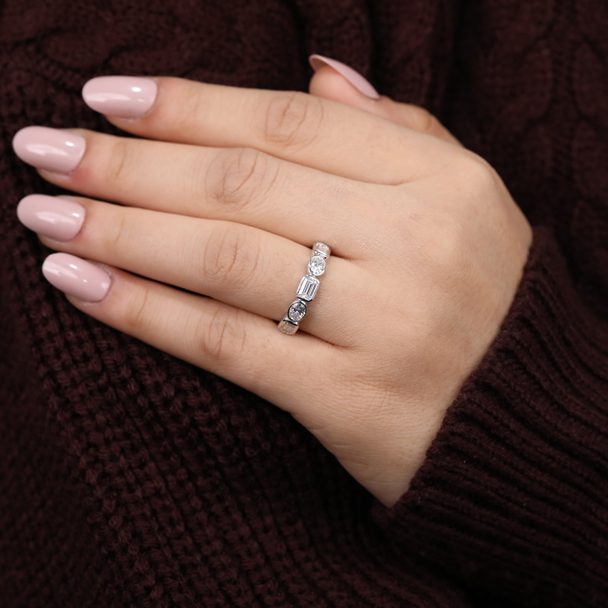 Lab-grown diamond ring with a geometric mix of emerald, oval, and round stones across the band