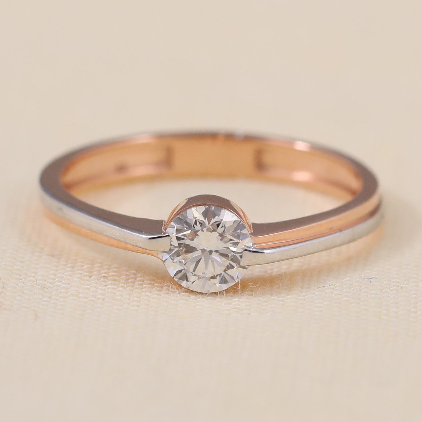 Two tone lab grown diamond ring featuring a modern bezel inspired center setting.