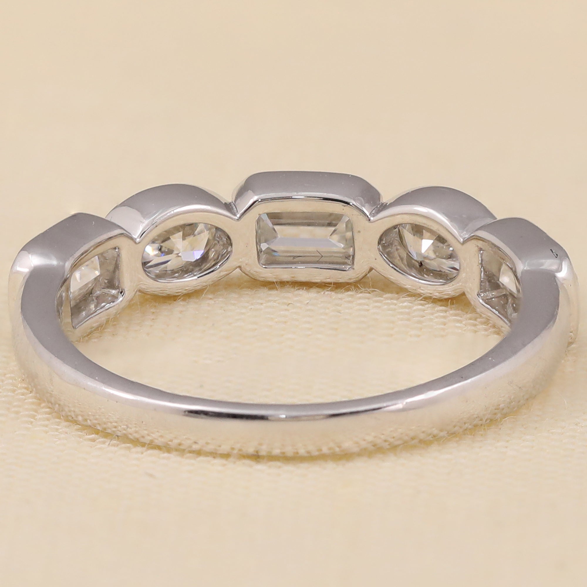 Unique five-stone lab diamond ring combining emerald, oval, and round diamonds in a sleek layout