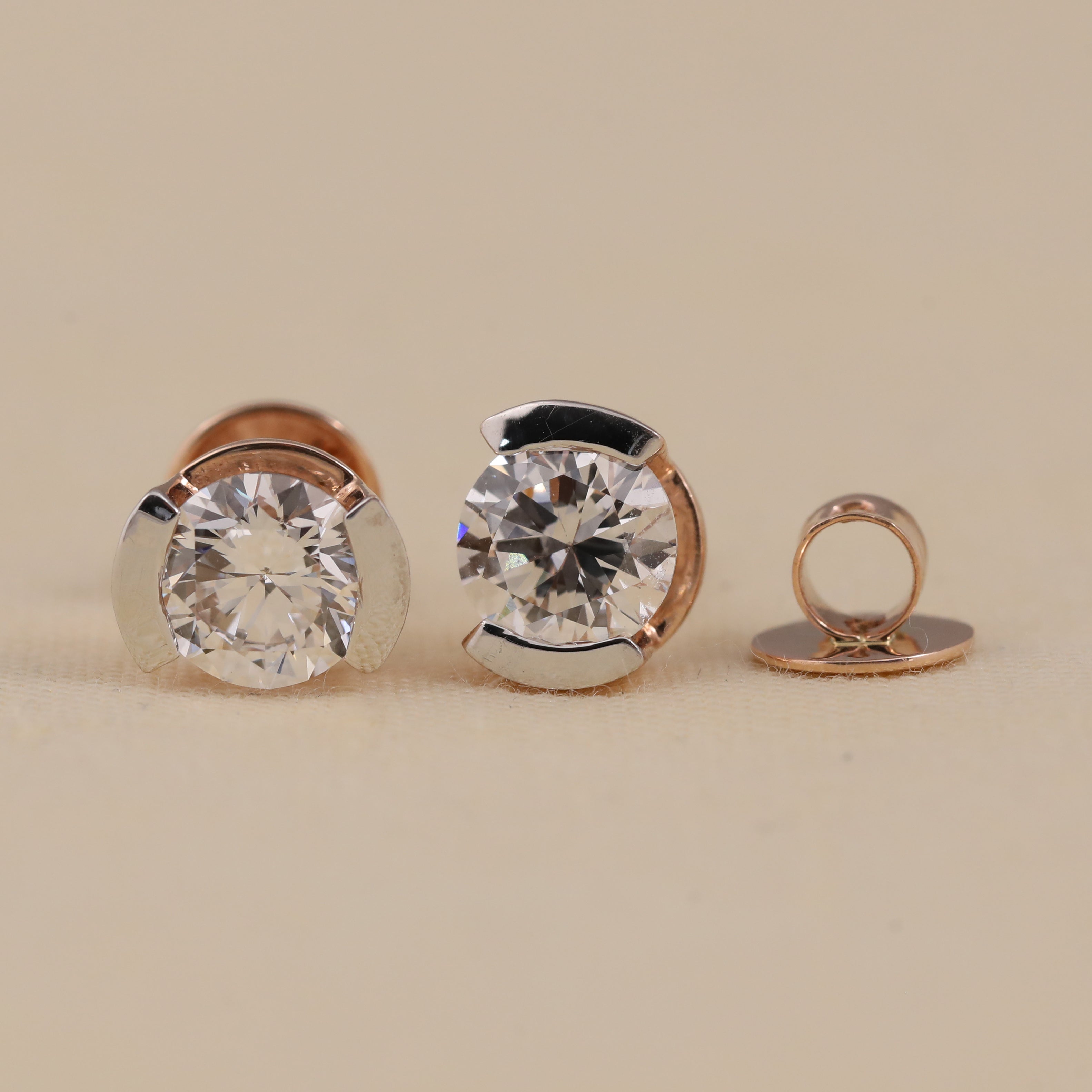 Minimalist half-bezel diamond studs ideal for engagement and celebrations.