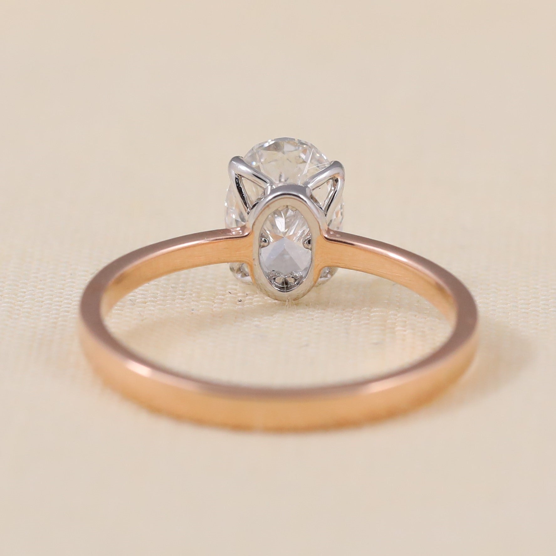 Classic oval lab grown diamond engagement ring with a clean modern band