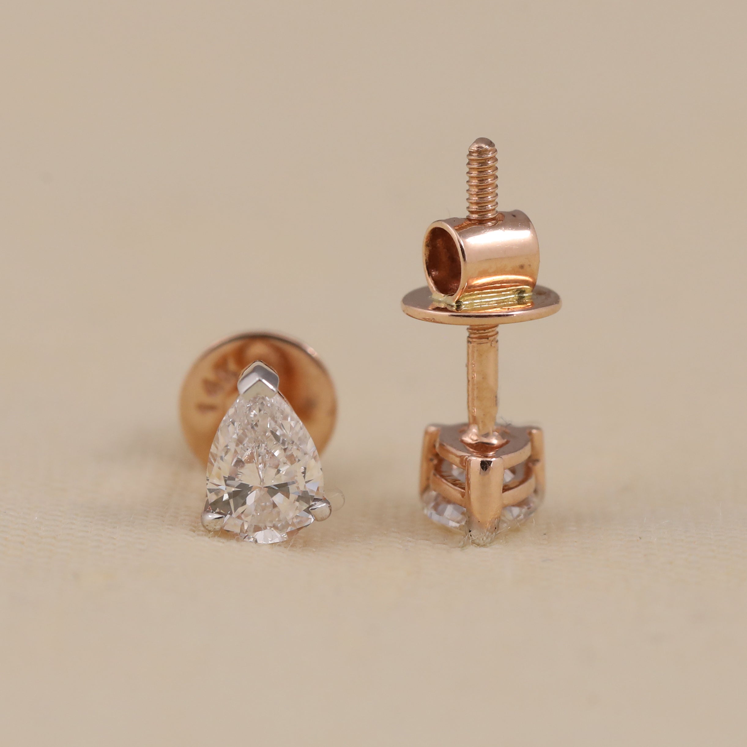 Classic pear-shaped diamond earrings styled for wedding or festive occasions.