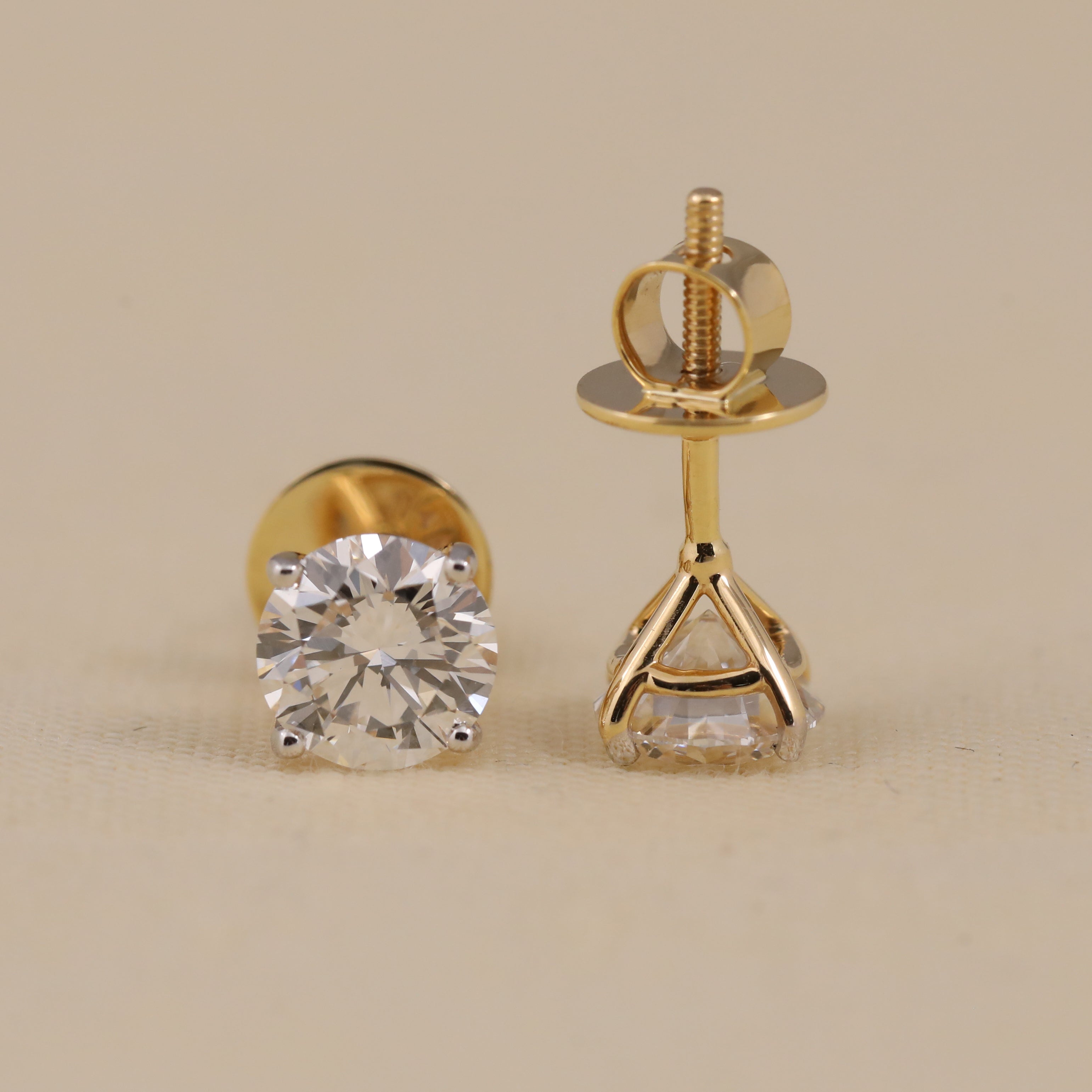 Classic round diamond earrings suited for engagement or wedding wear.