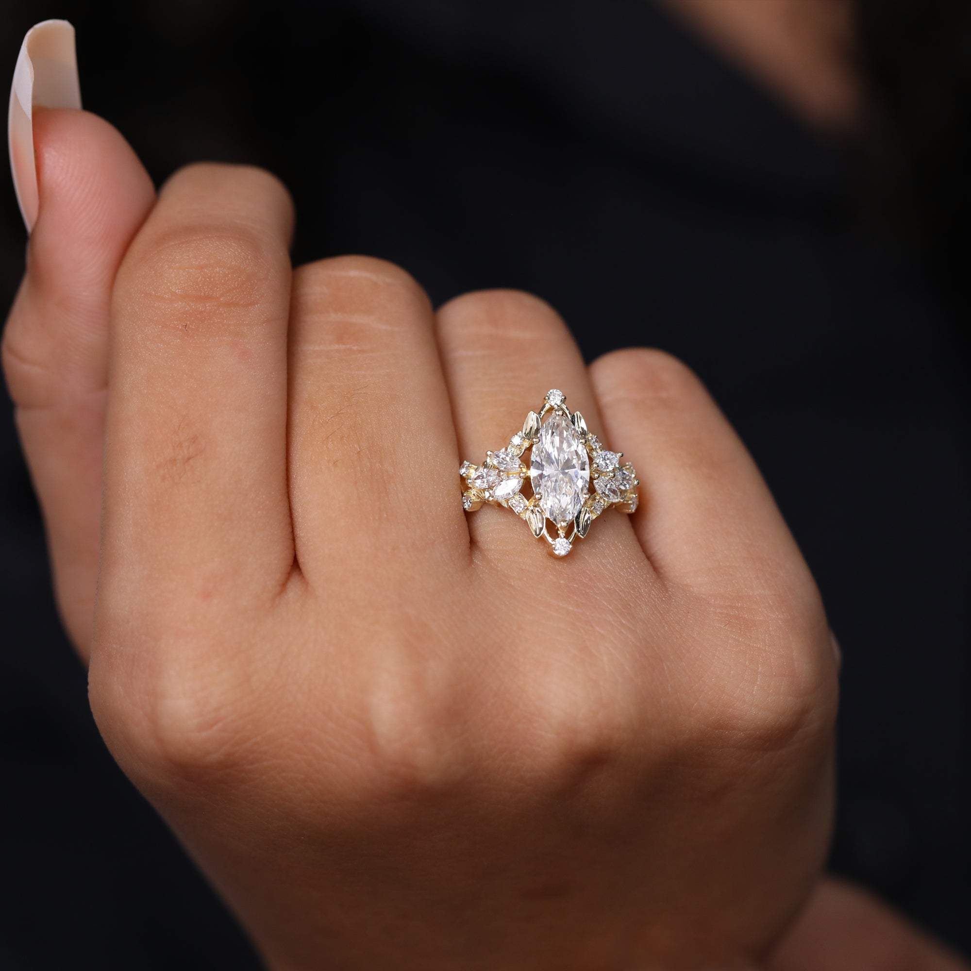 Ornate marquise-cut diamond engagement ring in yellow gold with floral cluster accents