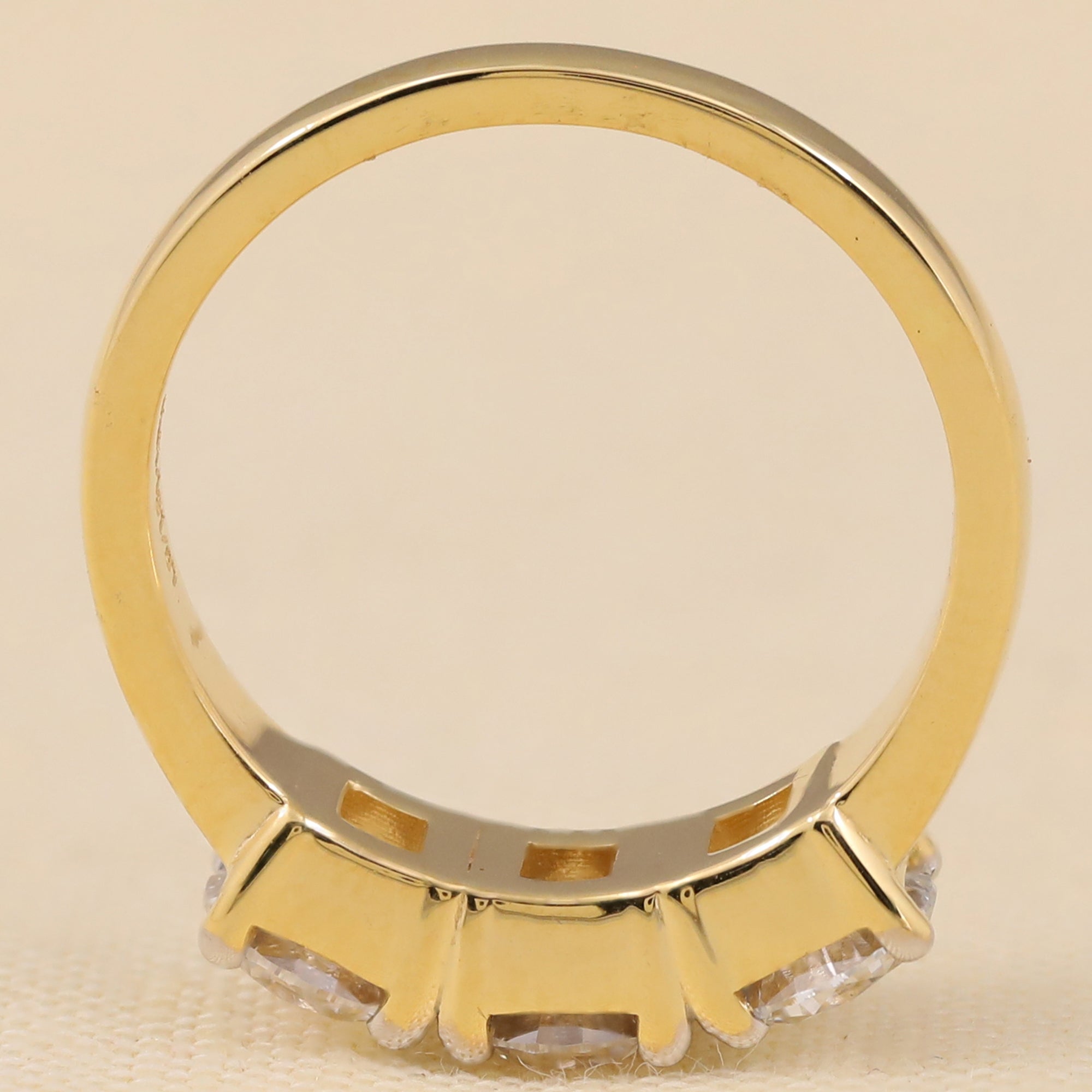 Lab-created round diamond three-stone ring offering balanced brilliance and symmetry