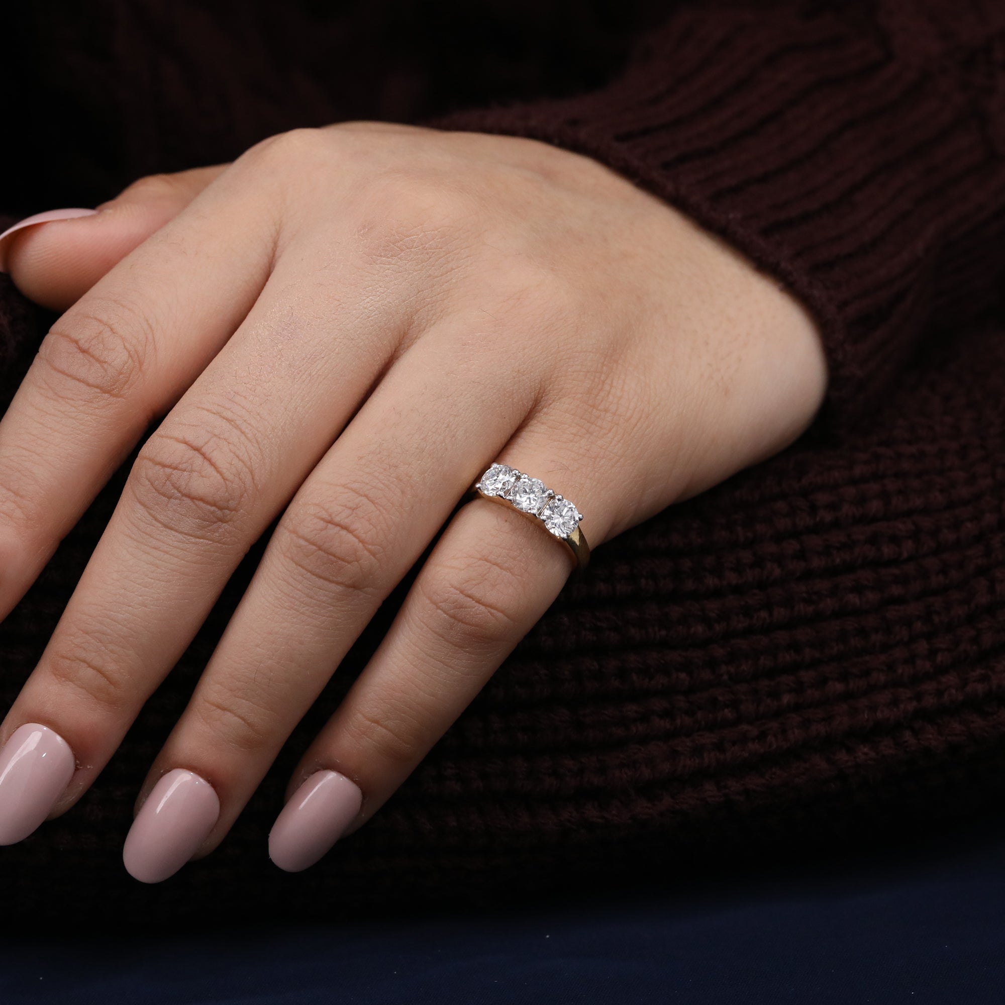 Lab diamond three-stone ring showcasing balanced round brilliance and clean styling