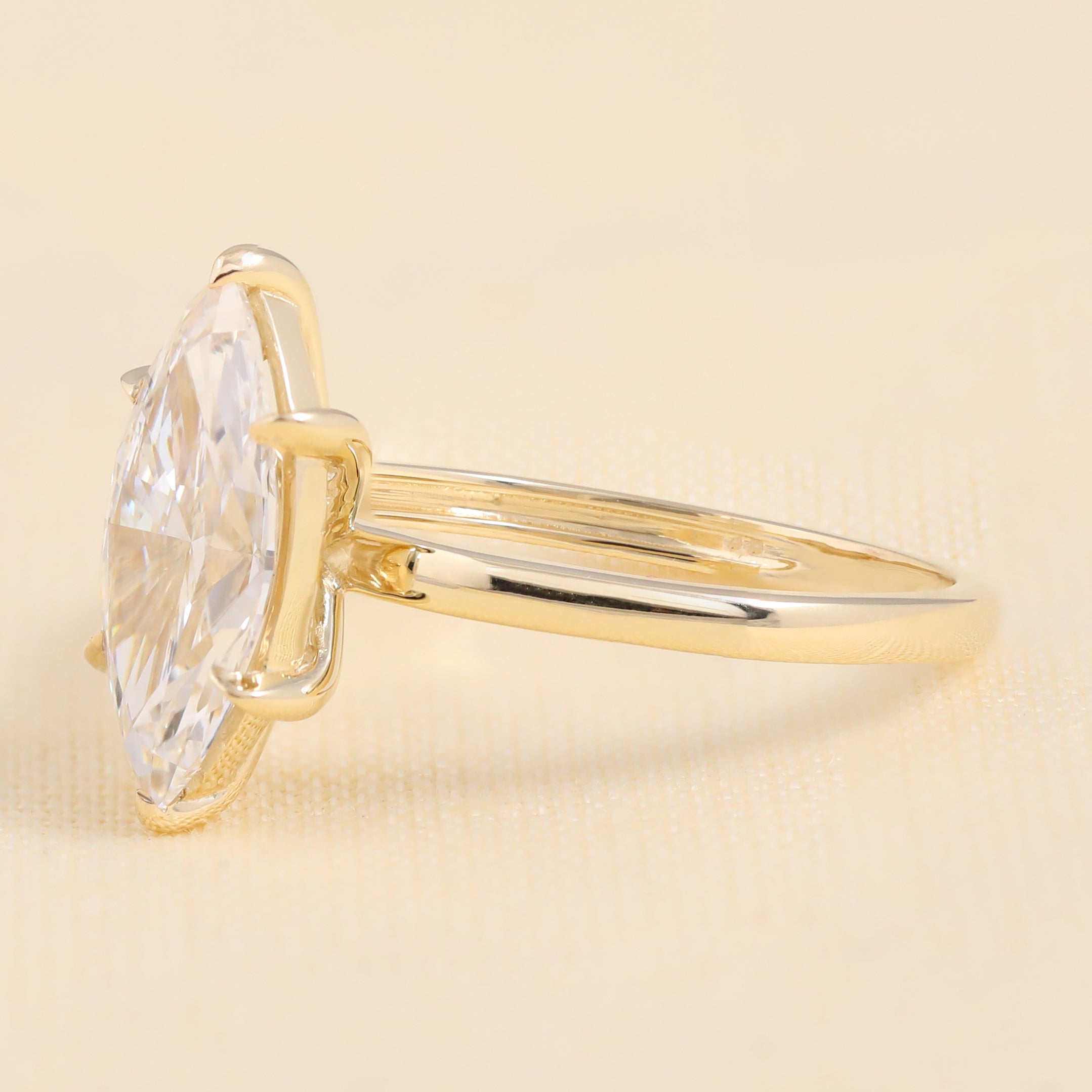Minimalist yellow gold marquise-cut diamond solitaire engagement ring