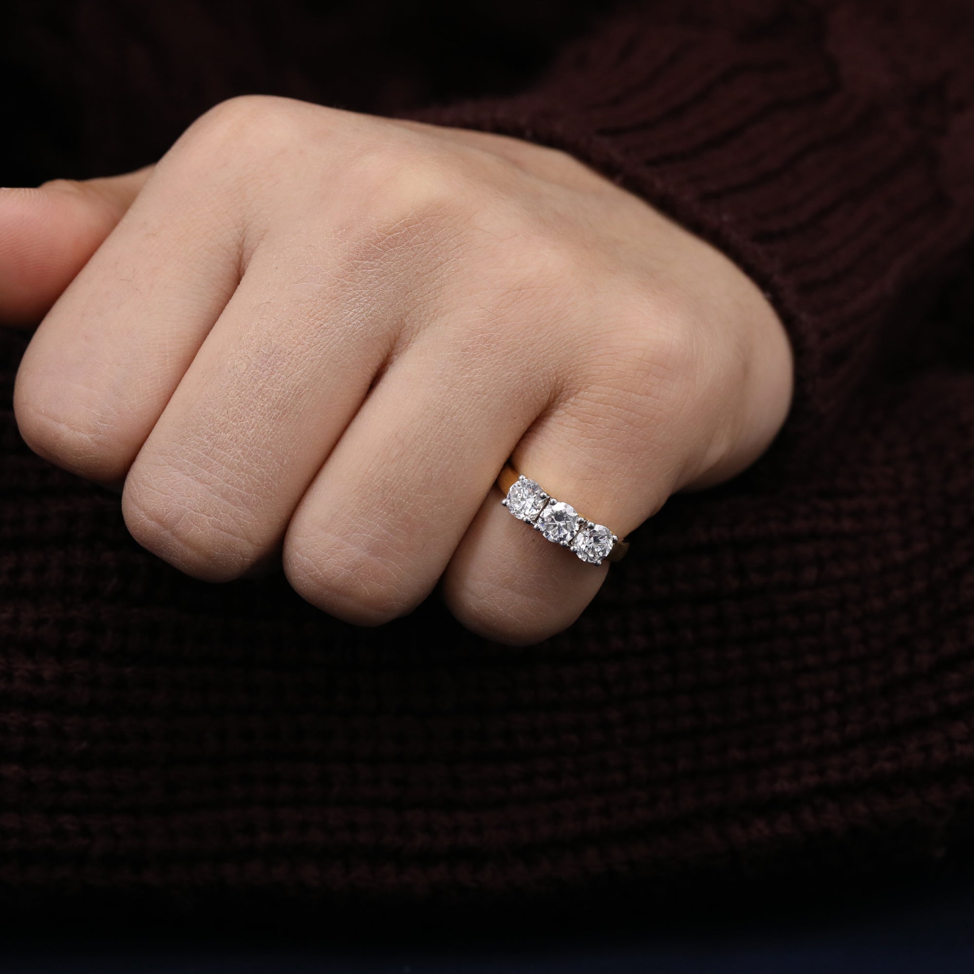 Modern three-stone lab-grown diamond ring featuring sparkling round cuts