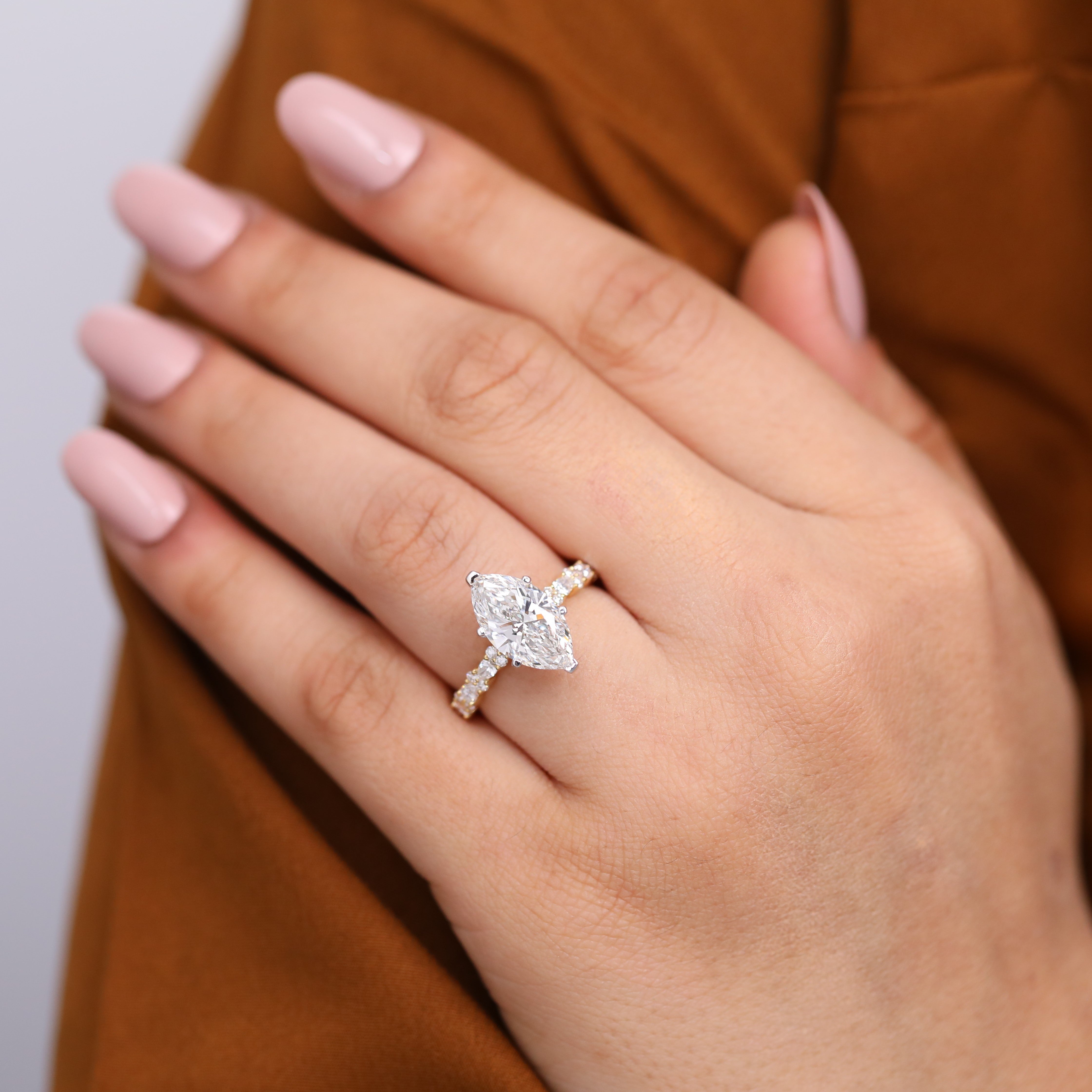 Modern marquise lab-grown diamond ring with a shimmering side-stone setting