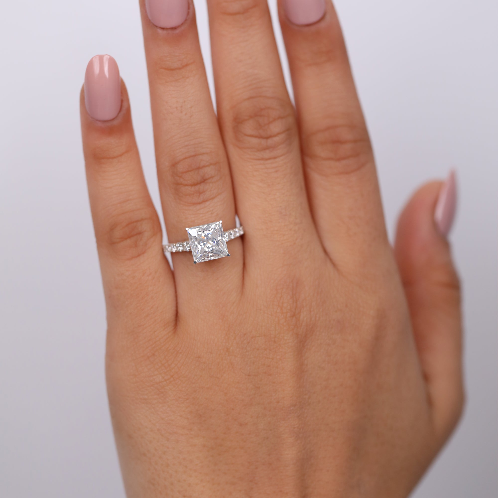 Brilliant princess cut solitaire engagement ring with pavé shank