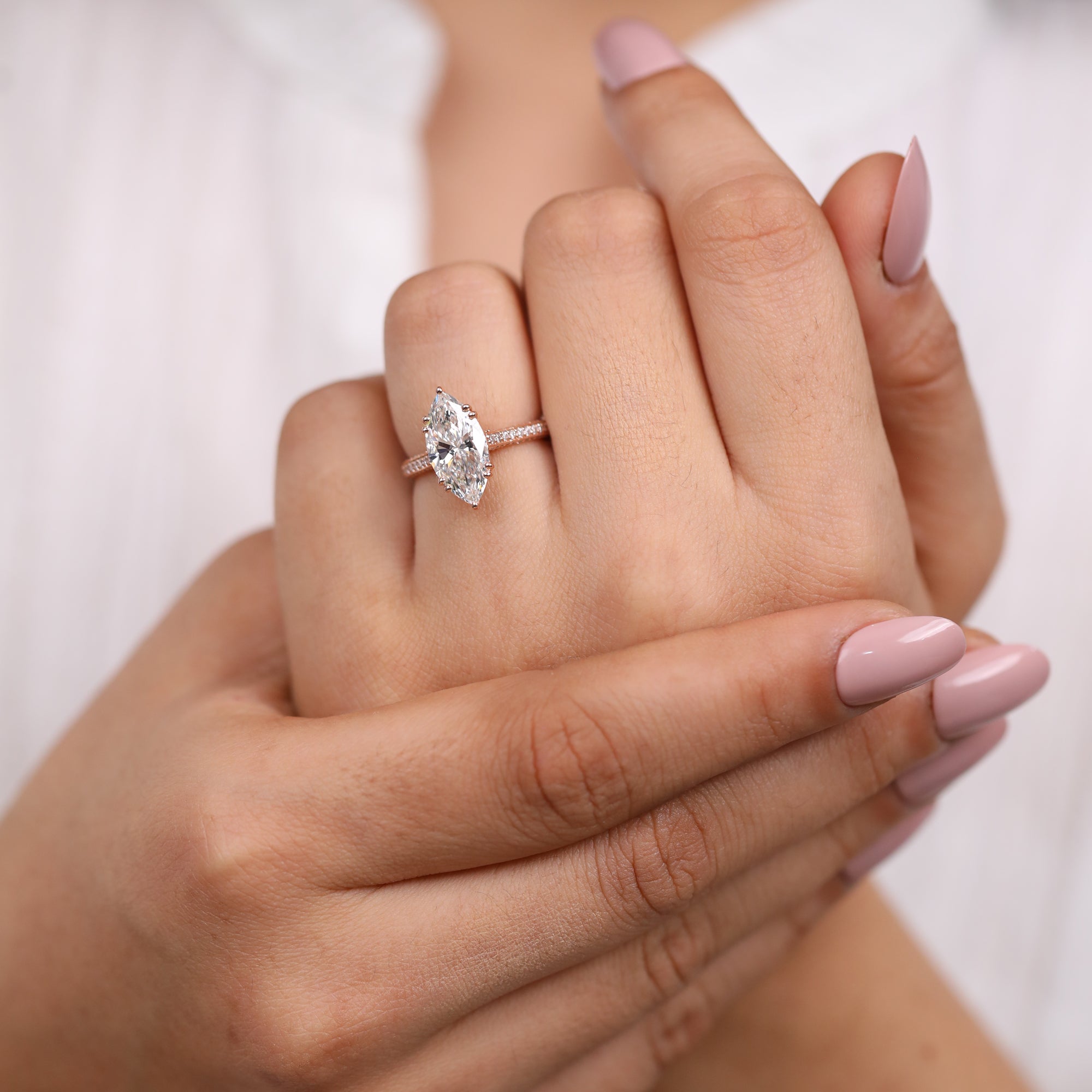 Modern rose gold ring featuring a marquise cut lab grown diamond center stone