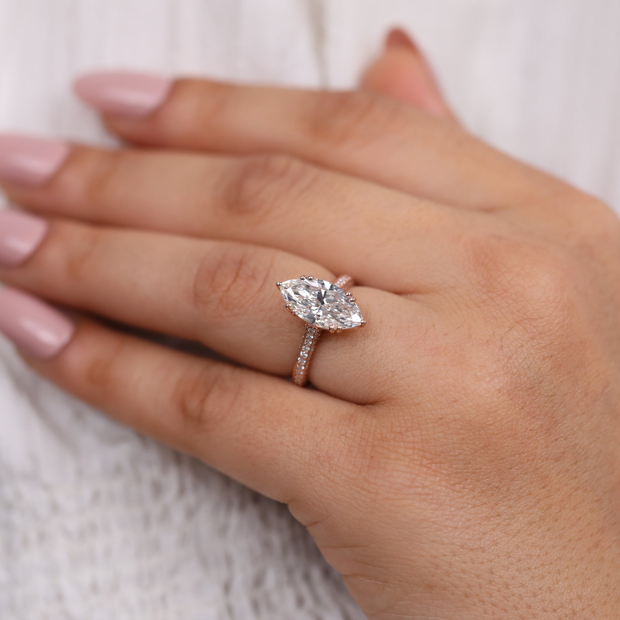 Marquise lab grown diamond engagement ring with rose gold pavé accents