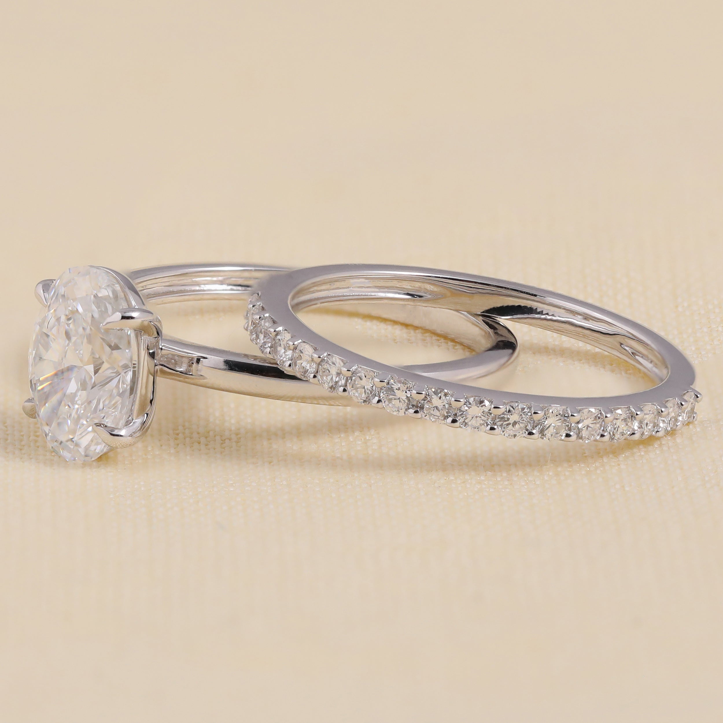 Oval solitaire engagement ring set with a slim pavé diamond wedding band