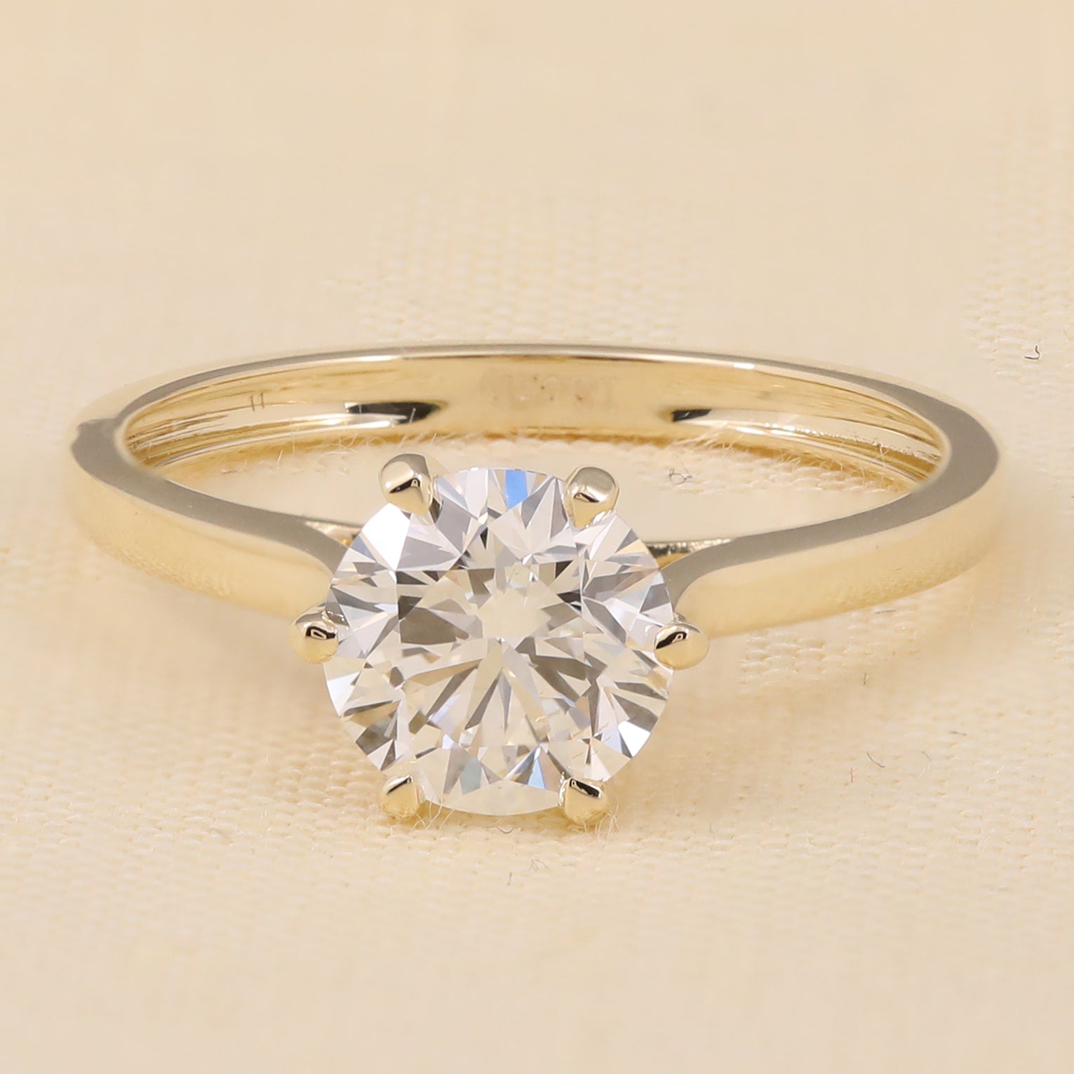 Round solitaire lab diamond engagement ring in a classic six prong design