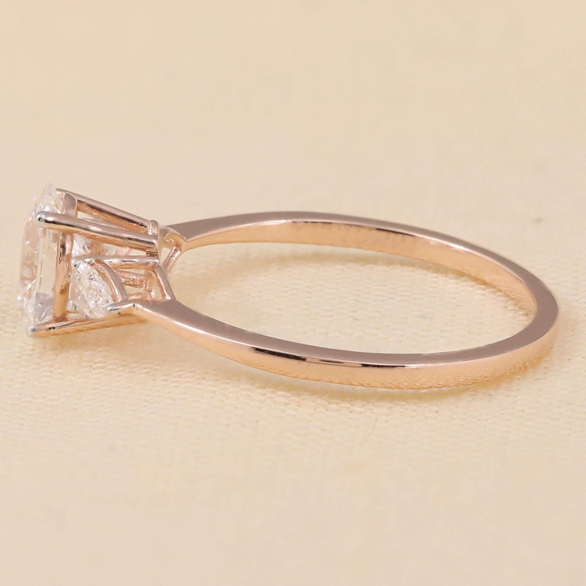 Oval lab diamond ring with sparkling pear-shaped lab diamonds on each side
