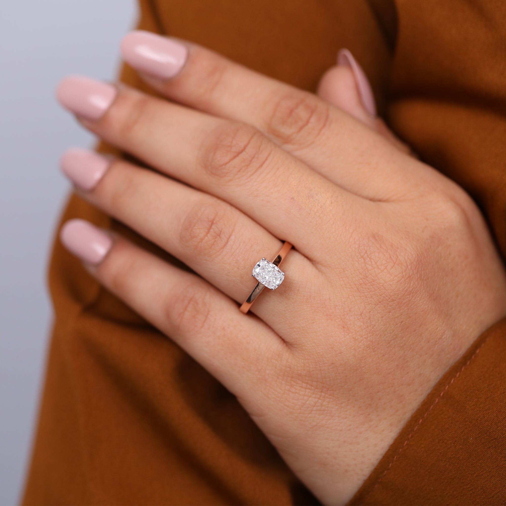 Minimalist rose gold engagement ring with a cushion cut lab grown diamond