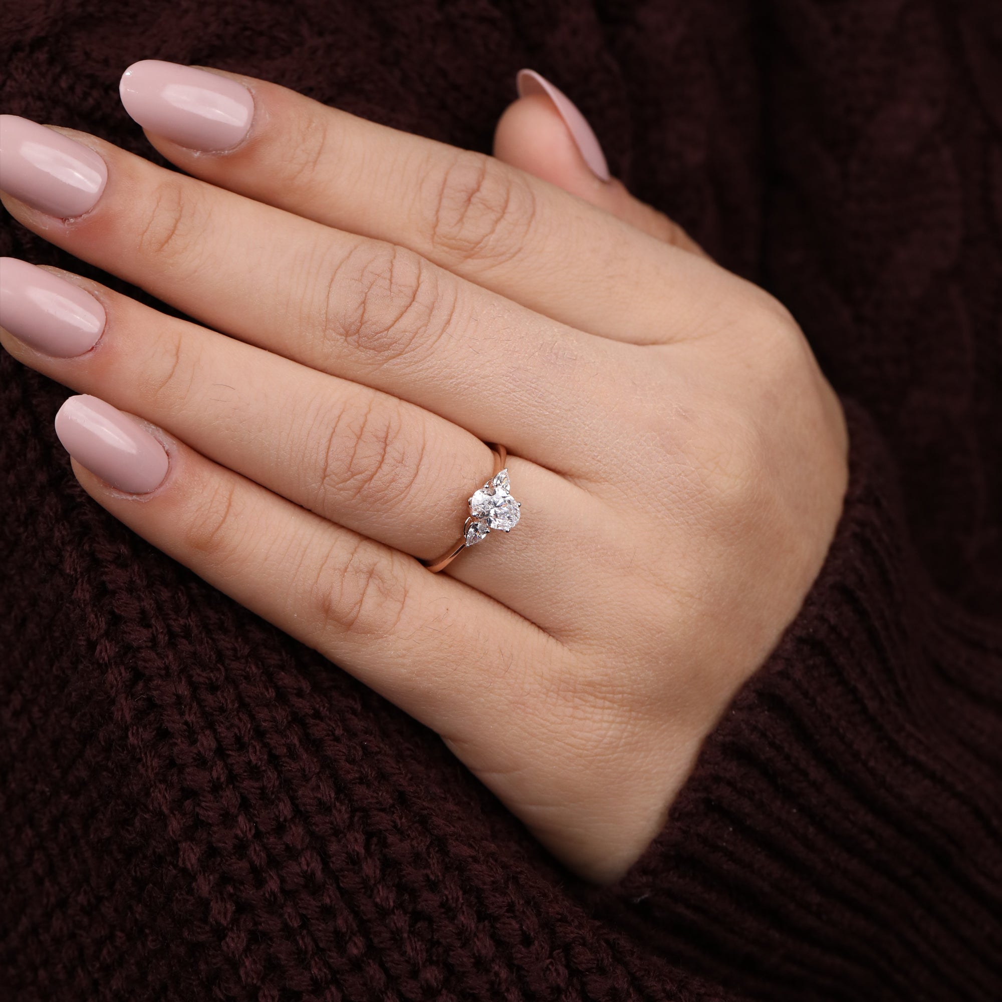 Timeless three-stone ring set with an oval lab diamond and pear-cut side diamonds