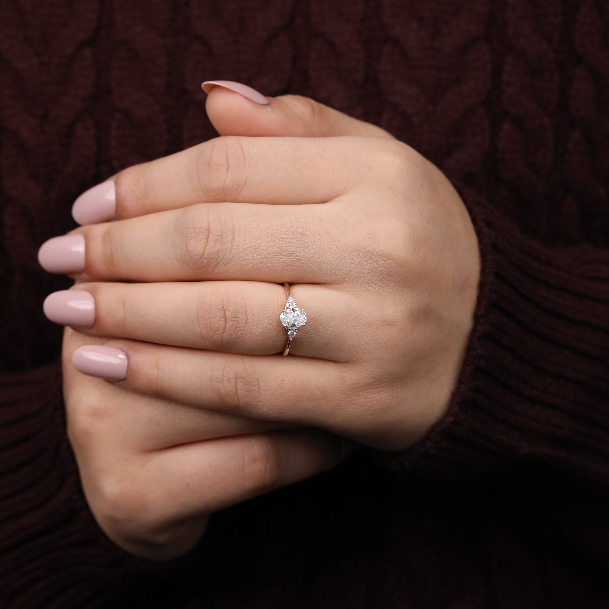 Minimalist engagement ring with an oval lab diamond and pear-cut side stones