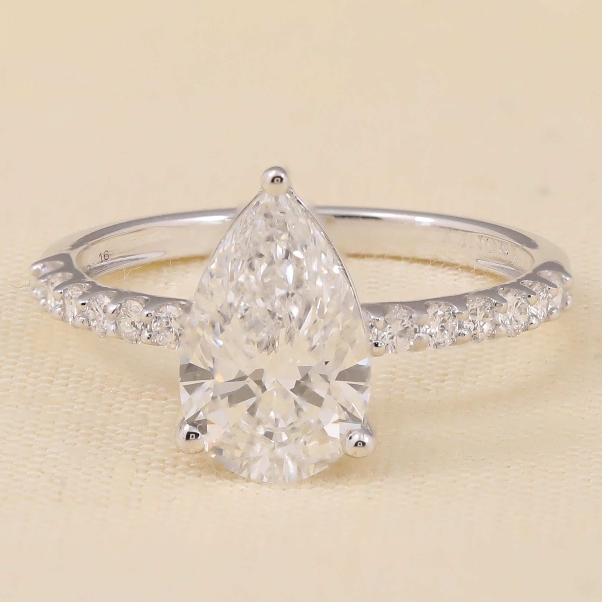 Pear-shaped lab diamond engagement ring with a sparkling lab diamond band