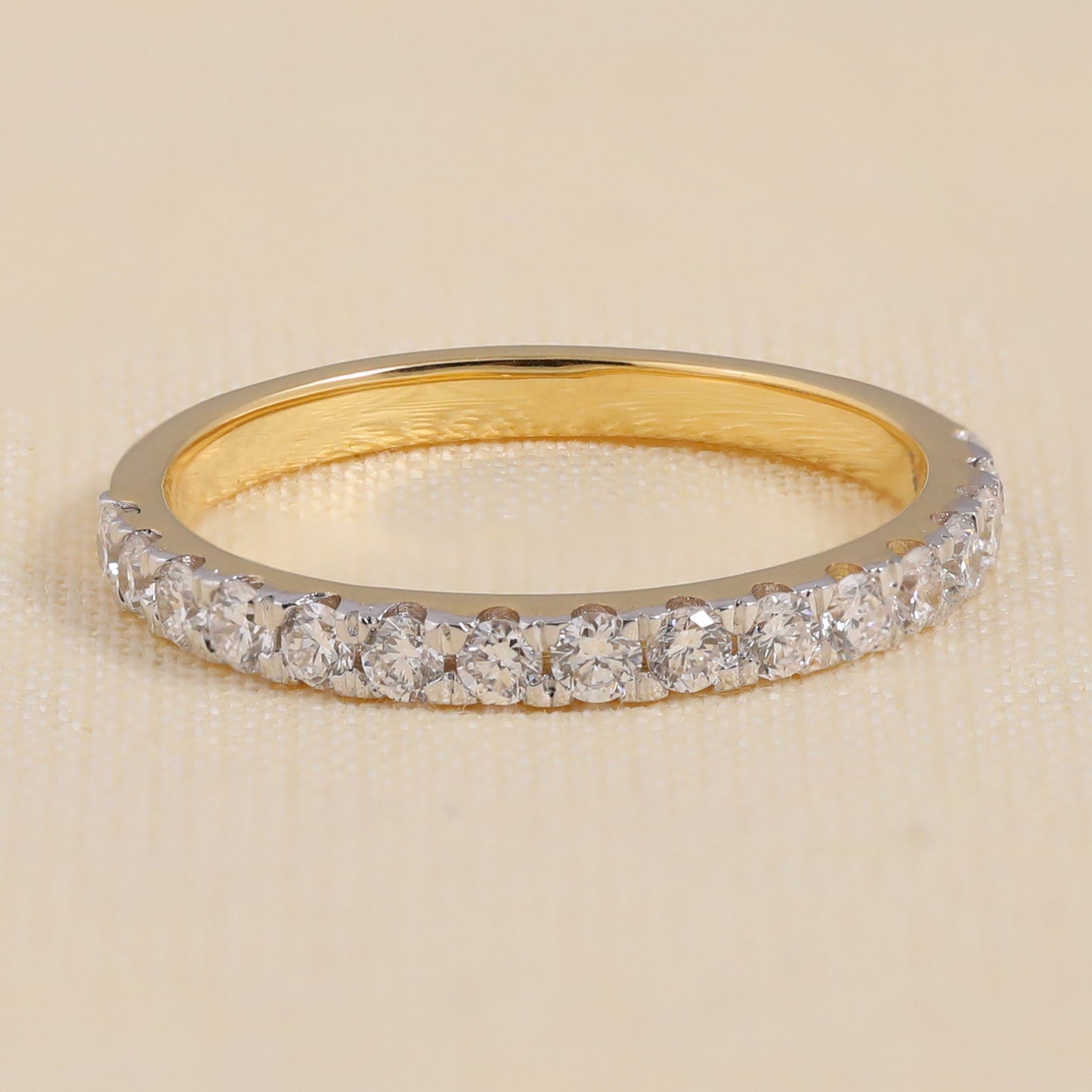Yellow gold pavé diamond band featuring a full row of brilliant round cut stones for a luxurious finish.