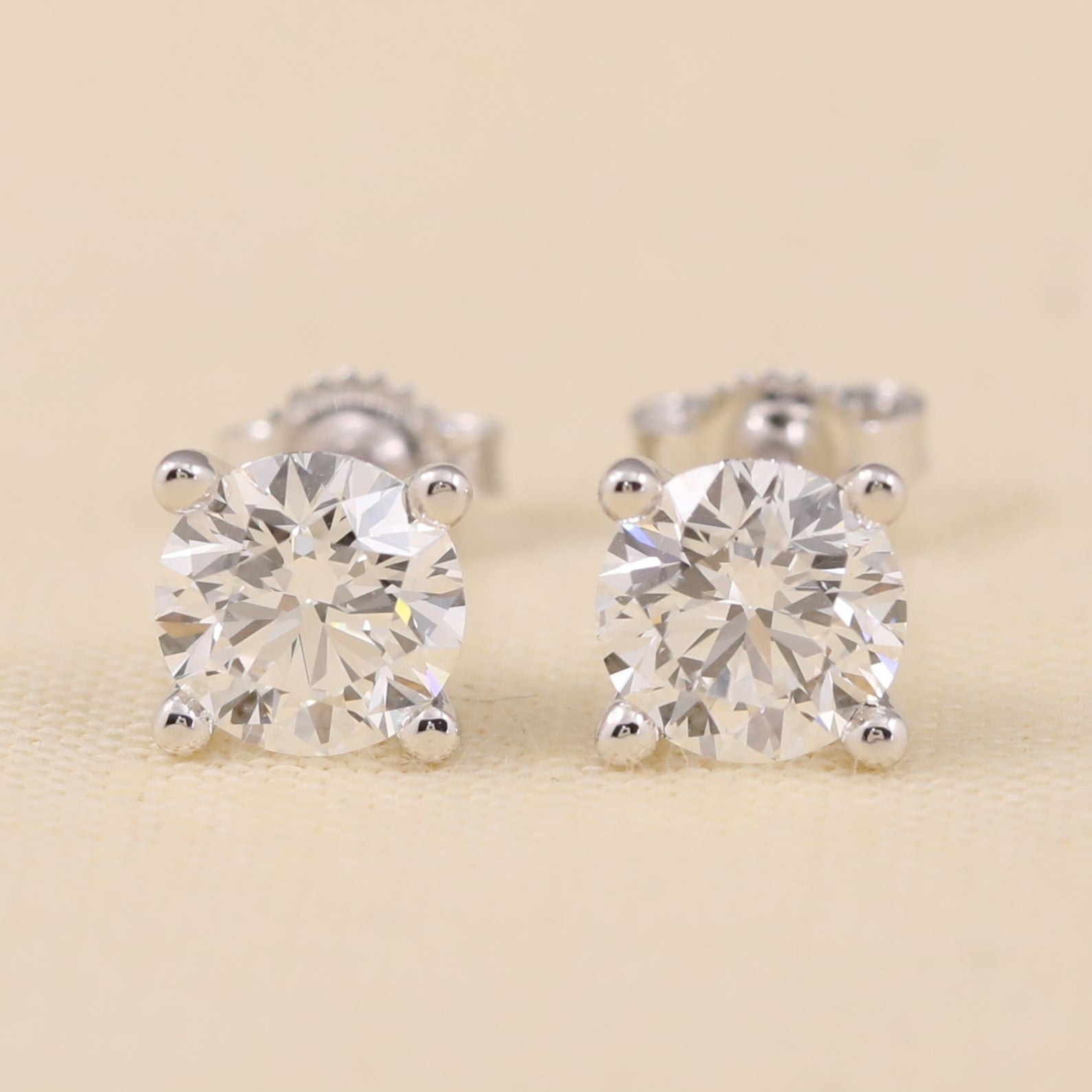 Classic round lab diamond stud earrings with sleek prong design.