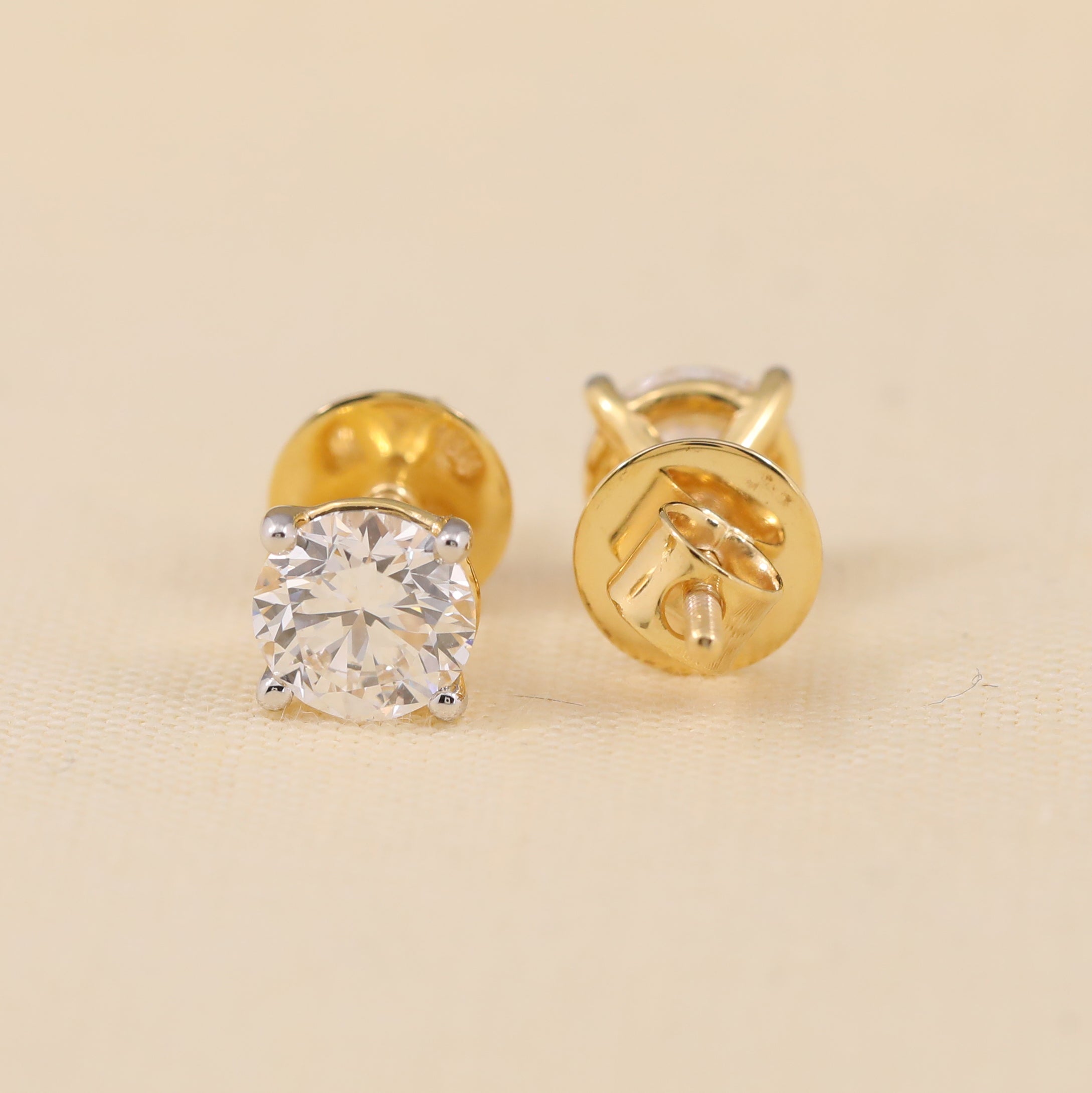 Classic round cut diamond earrings suited for daily wear or gifting.